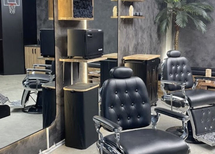 Interior of First Rule Barber in Sippy Downs, Queensland, AU featuring classic black barber chairs and mirrors.
