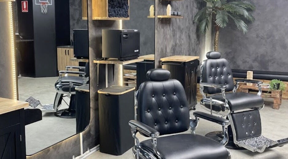 Interior of First Rule Barber in Sippy Downs, Queensland, AU featuring classic black barber chairs and mirrors.