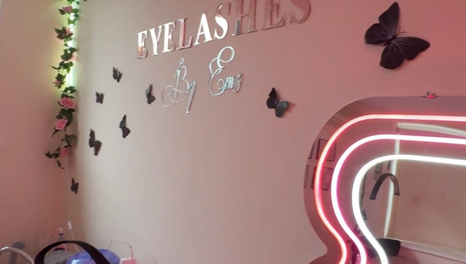Chic interior of Eyelashes By Ems in Leatherhead, England, GB with butterfly decor and neon mirror lighting.
