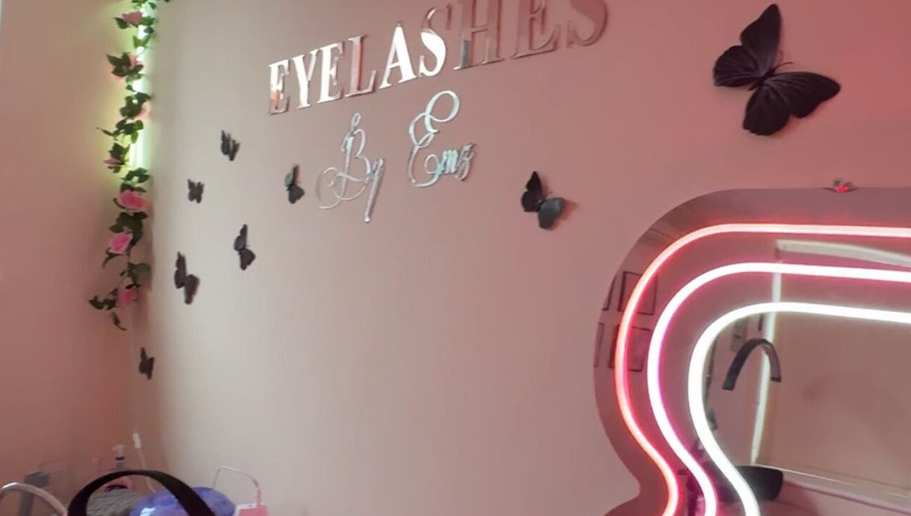 Chic interior of Eyelashes By Ems in Leatherhead, England, GB with butterfly decor and neon mirror lighting.