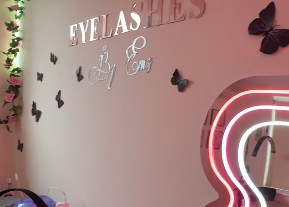Chic interior of Eyelashes By Ems in Leatherhead, England, GB with butterfly decor and neon mirror lighting.