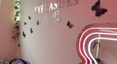 Chic interior of Eyelashes By Ems in Leatherhead, England, GB with butterfly decor and neon mirror lighting.