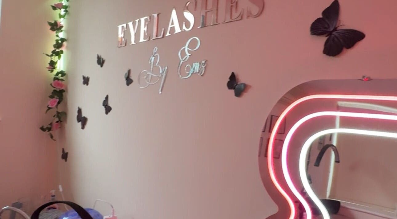 Chic interior of Eyelashes By Ems in Leatherhead, England, GB with butterfly decor and neon mirror lighting.