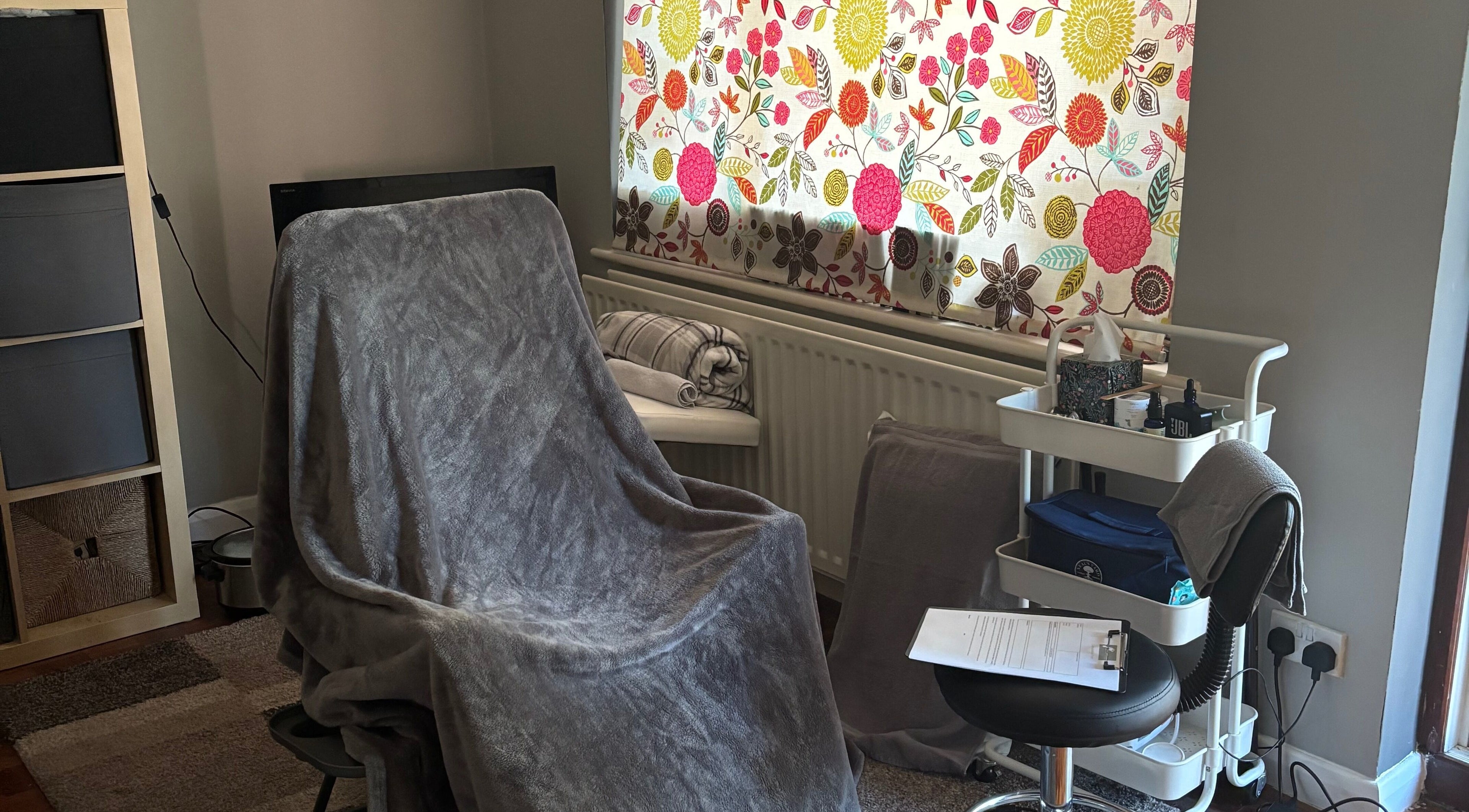 Peaceful therapy room at Clare Reflexology (Prestwood) with floral curtain in Prestwood, England, GB.