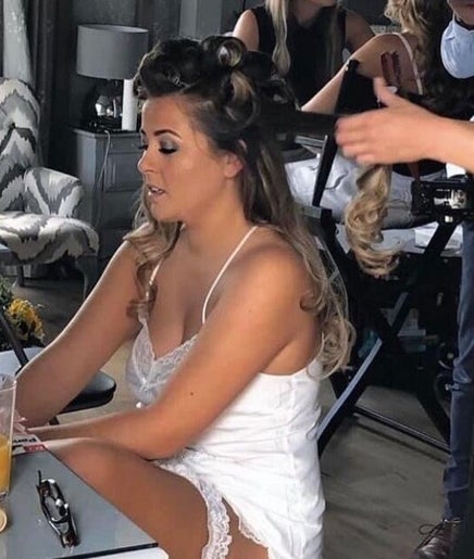 Stylist perfecting hair at Emma Lock Hair and Makeup, South Benfleet, England, GB. Elegant setting for beauty services.