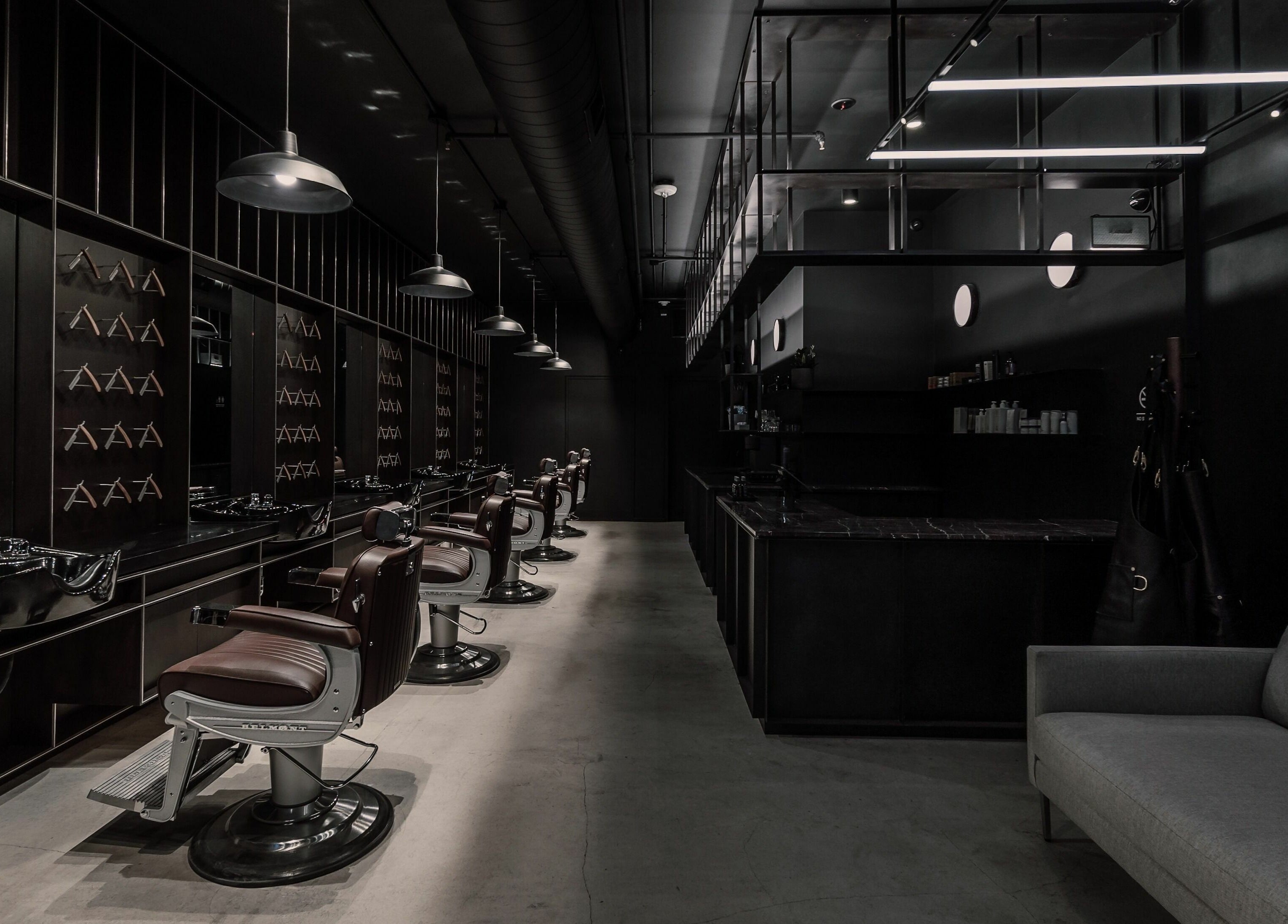Sleek barber chairs and modern interior at NoMad, New York, New York, US.