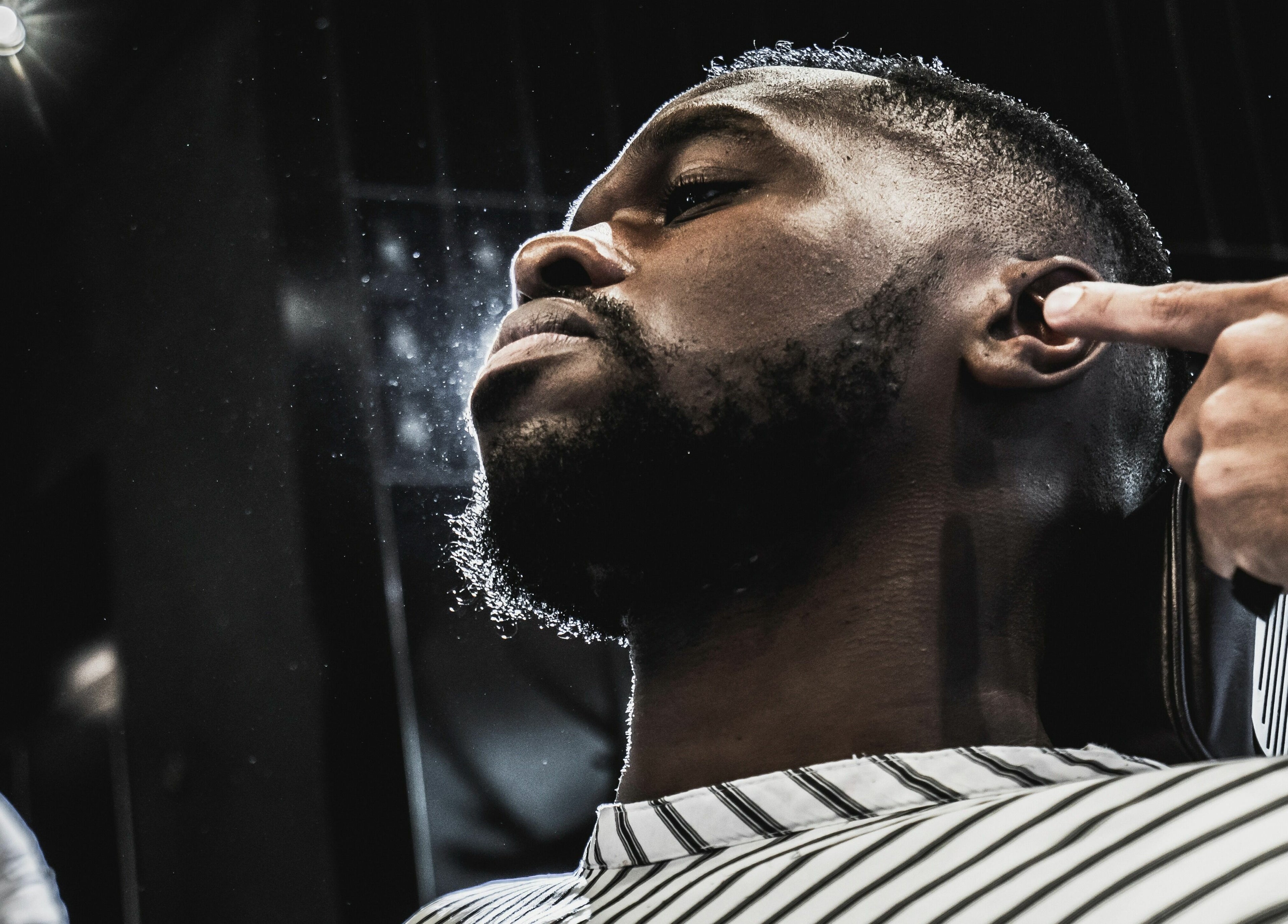 Man receiving a precise beard trim at NoMad, New York, New York, US, showcasing expert grooming.