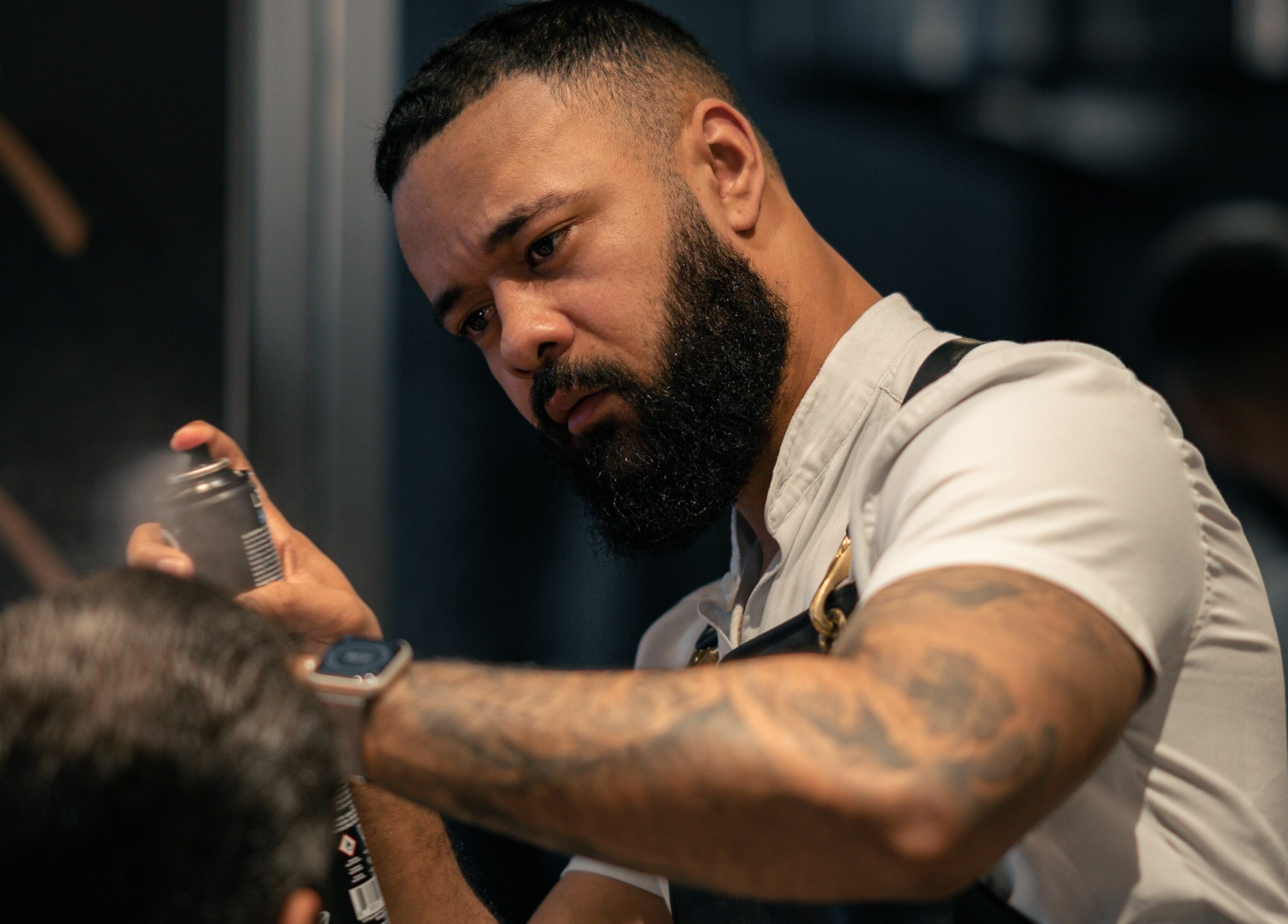 Barber styling a client's hair at NoMad, New York, New York, US, with professional focus.