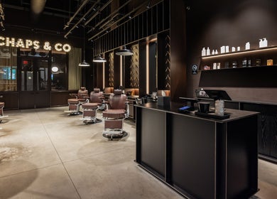 Elegant interior of Grand Central salon in New York, New York, US with leather chairs and sleek decor.