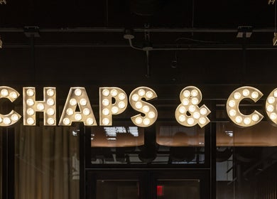 Illuminated Chaps & Co sign at Grand Central, New York, New York, US, evokes an upscale ambiance.