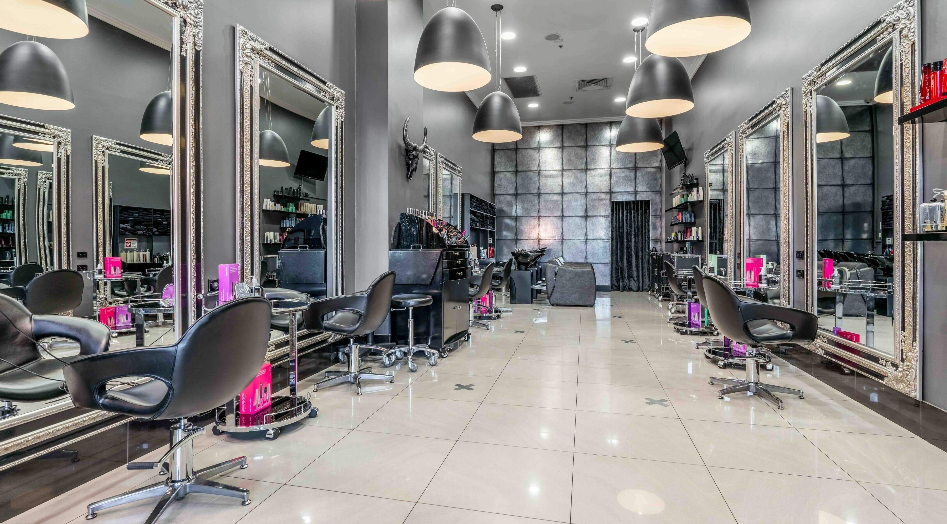 Modern salon interior at JAD Hair Sydney, Redfern, New South Wales, AU with sleek chairs and stylish mirrors.