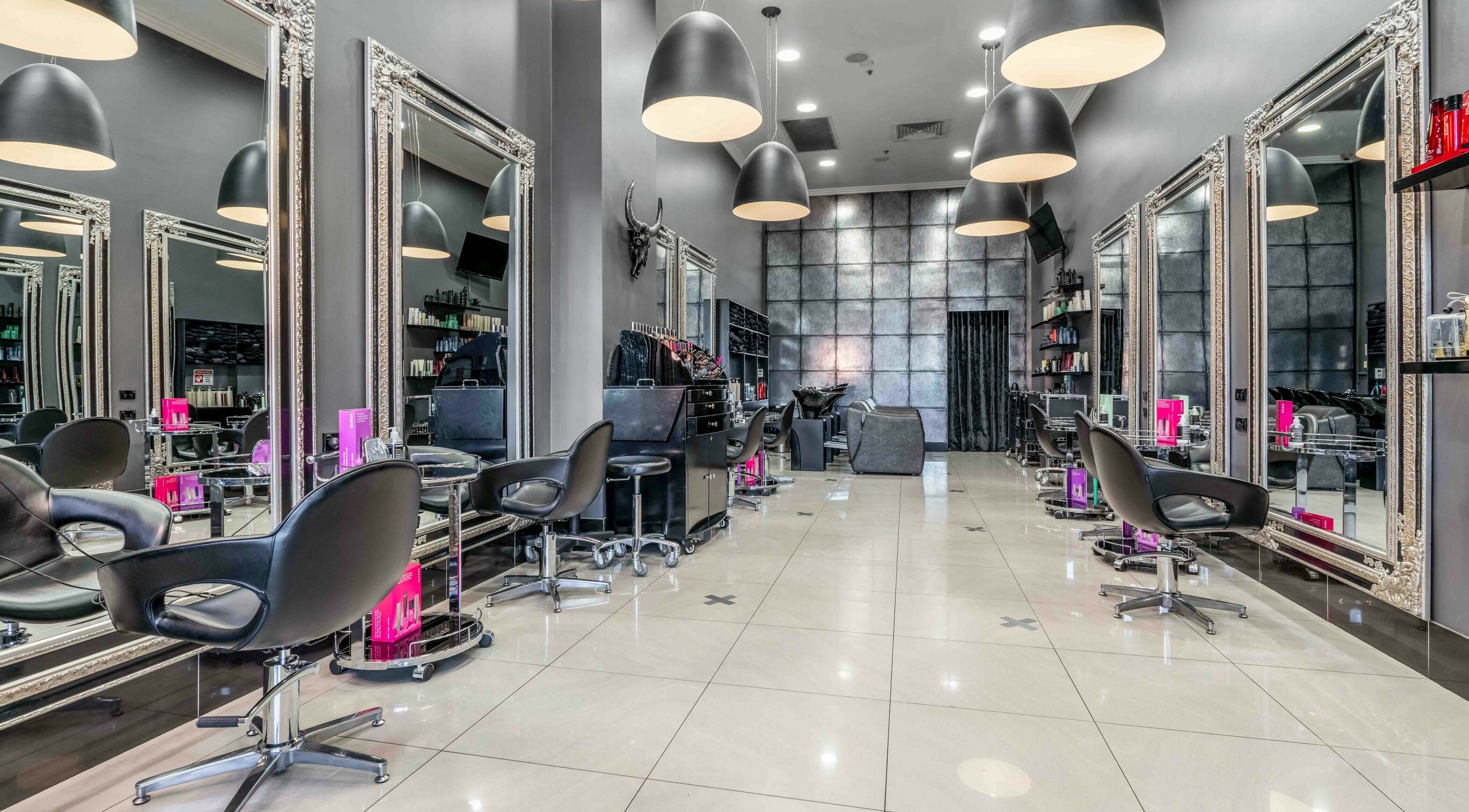 Modern salon interior at JAD Hair Sydney, Redfern, New South Wales, AU with sleek chairs and stylish mirrors.