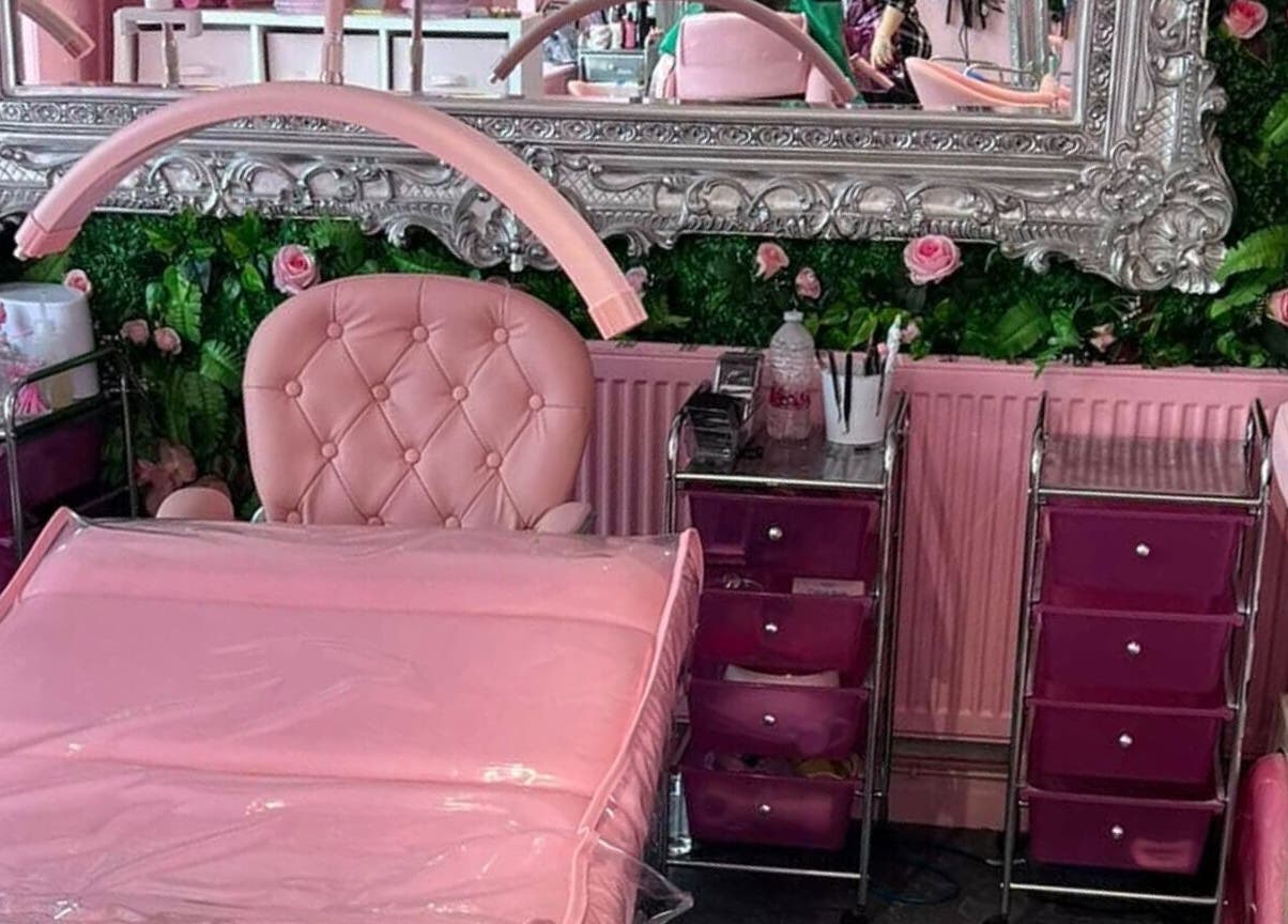 Luxurious pink beauty room at L.C Beauty and Aesthetics, Wigan, England, GB with ornate mirror and plush chairs.