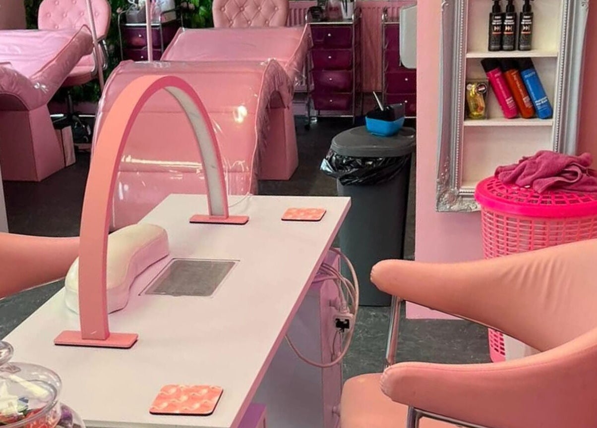 Chic pink interior of L.C Beauty and Aesthetics in Wigan, England, GB, featuring elegant manicure stations.