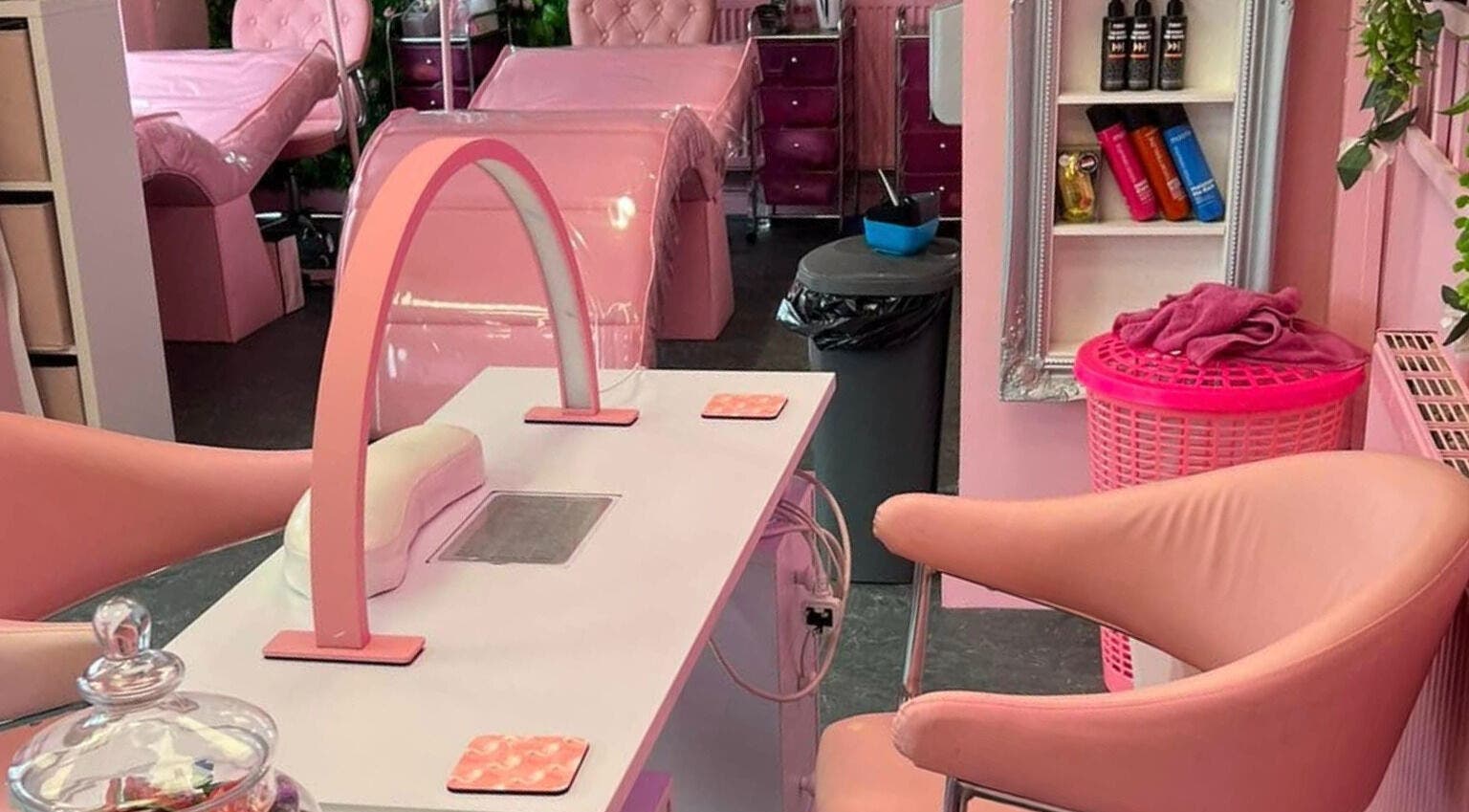 Chic pink interior of L.C Beauty and Aesthetics in Wigan, England, GB, featuring elegant manicure stations.
