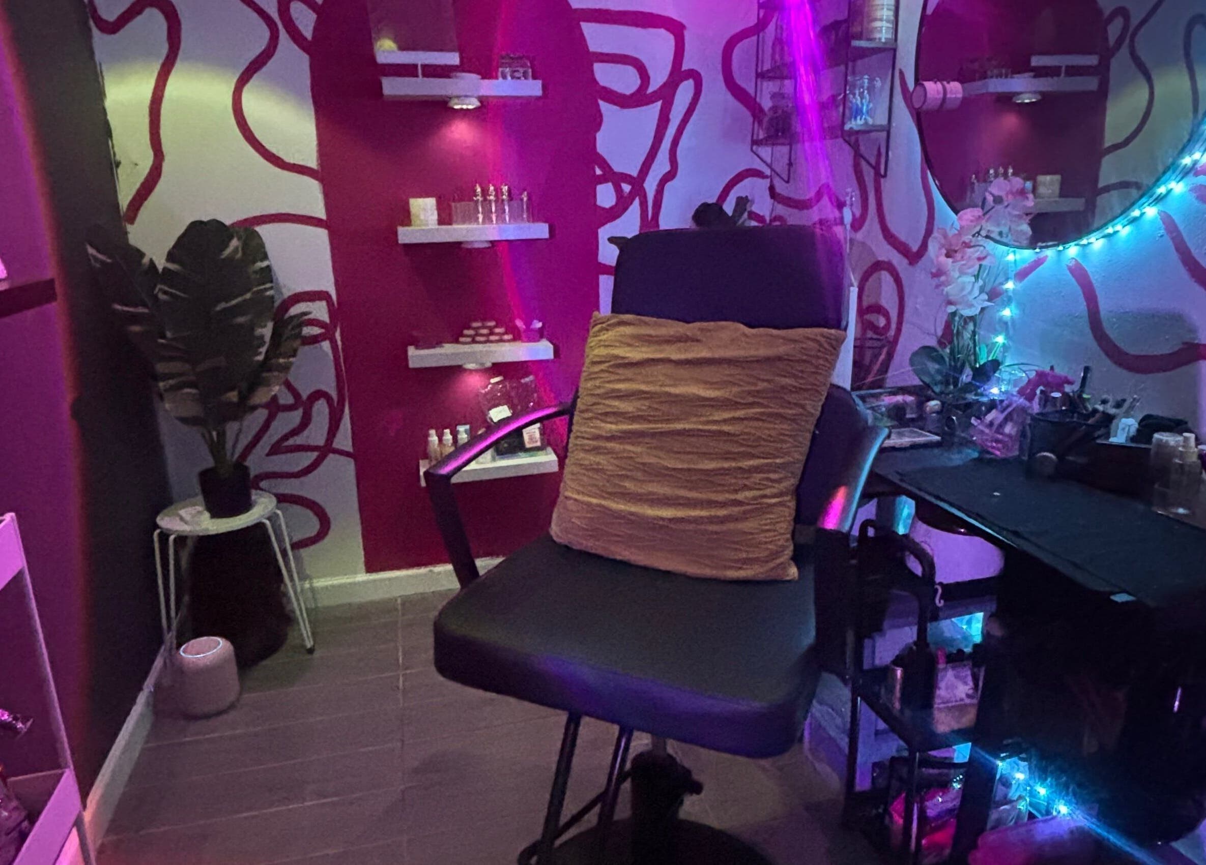 Vibrant beauty room at Dame House Co. in Stonecrest, Georgia, US with colorful lighting and chic decor.