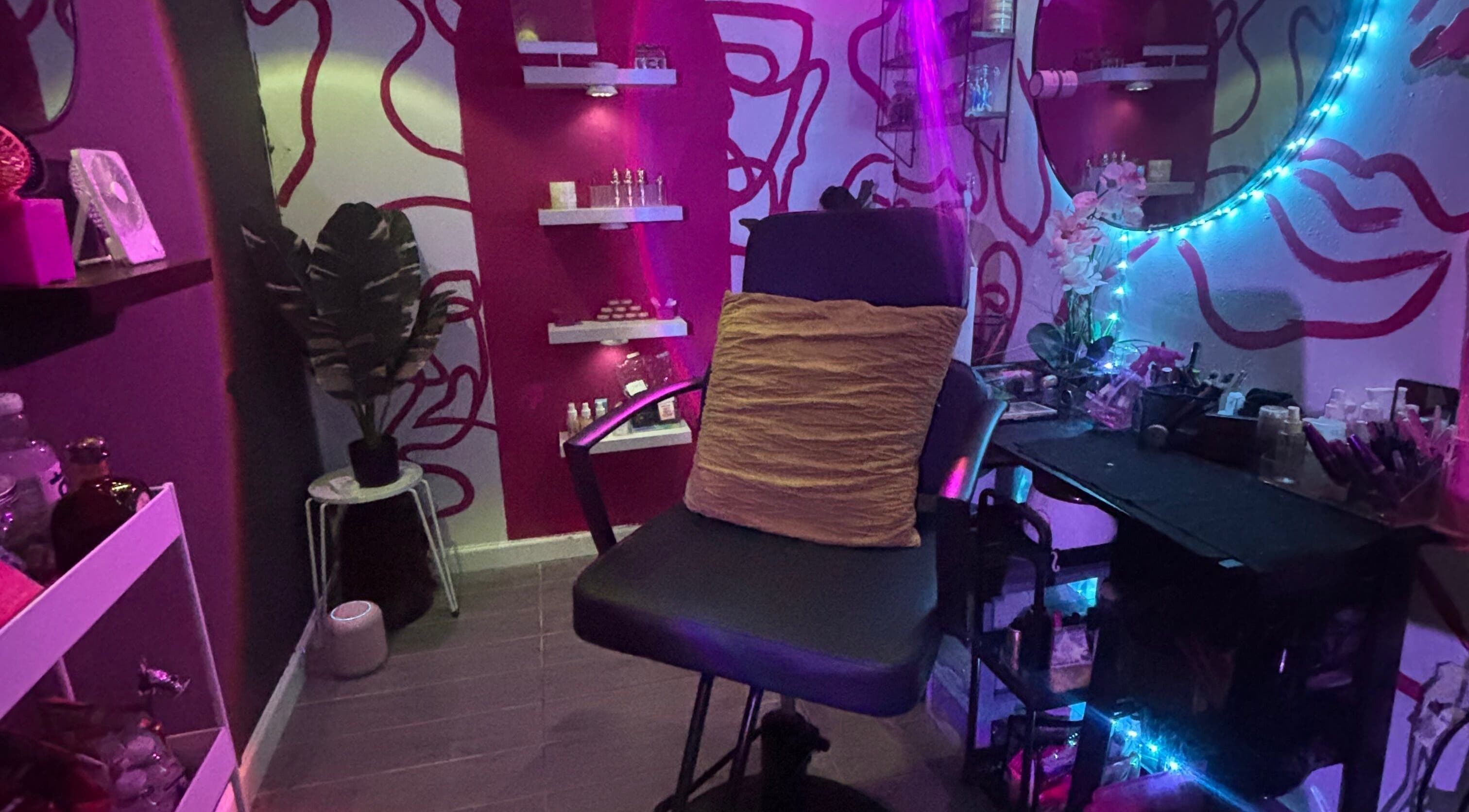 Vibrant beauty room at Dame House Co. in Stonecrest, Georgia, US with colorful lighting and chic decor.