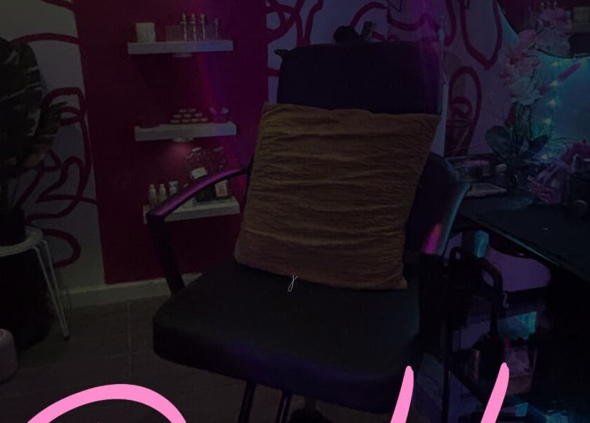 Cozy salon chair in Dame House Co., Stonecrest, Georgia, US with ambient lighting and decor.