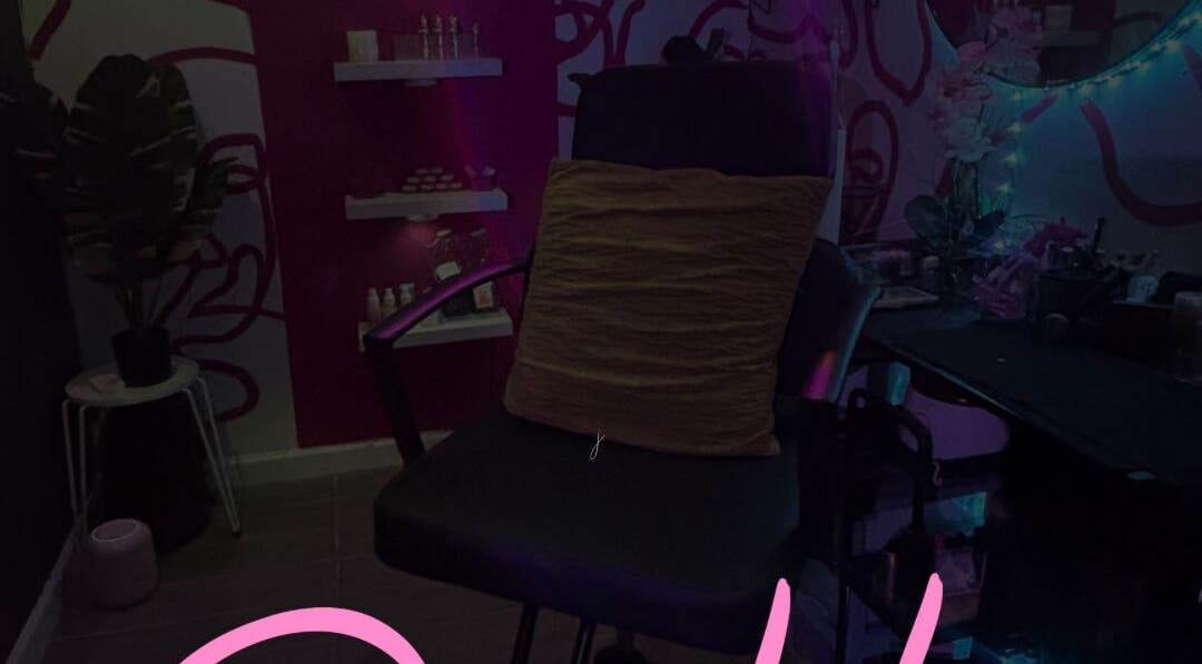 Cozy salon chair in Dame House Co., Stonecrest, Georgia, US with ambient lighting and decor.