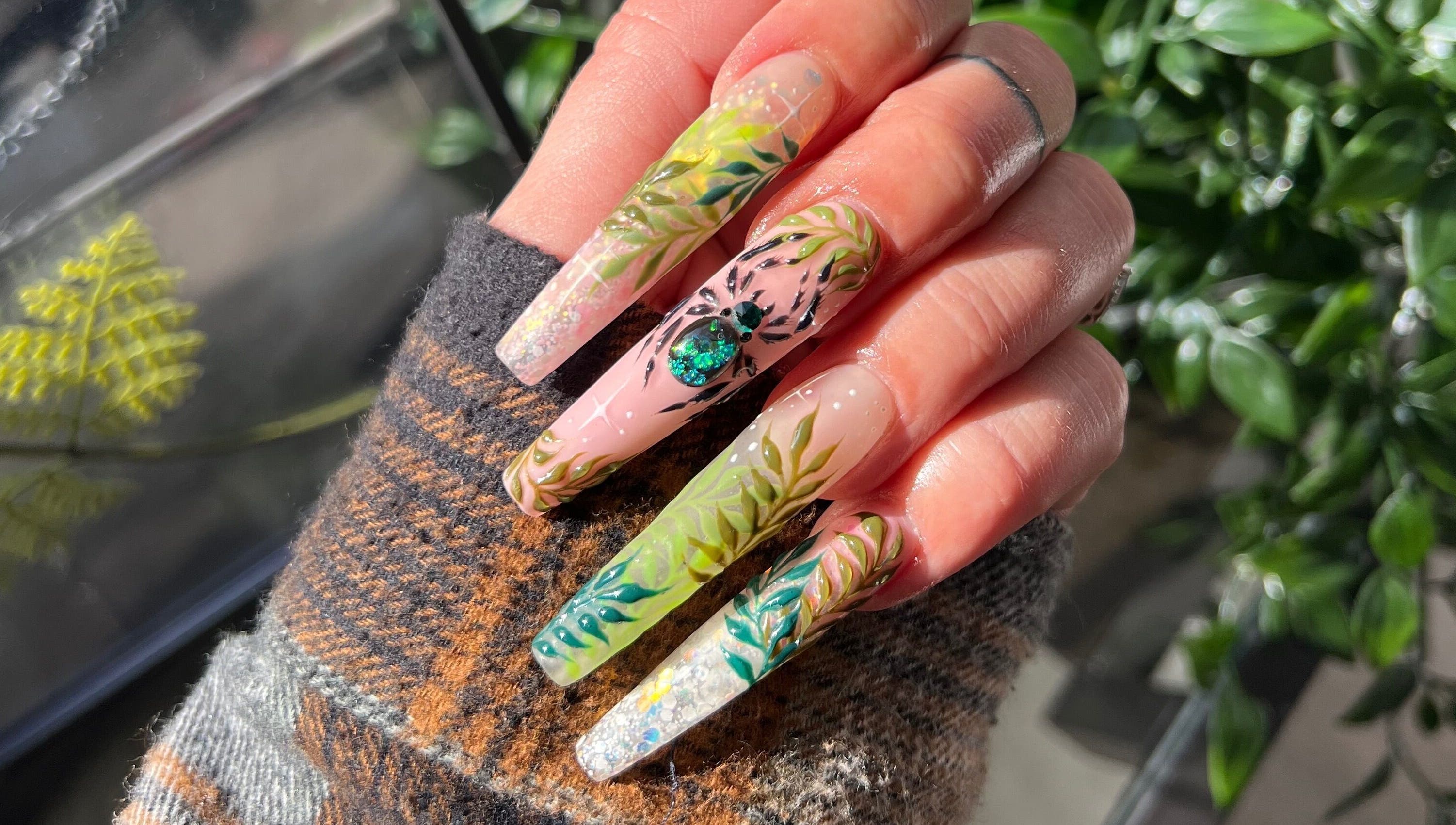 Intricate botanical nail art at Gatz Beauty Vision in Wellingborough, England, GB, showcasing detailed and vibrant designs.