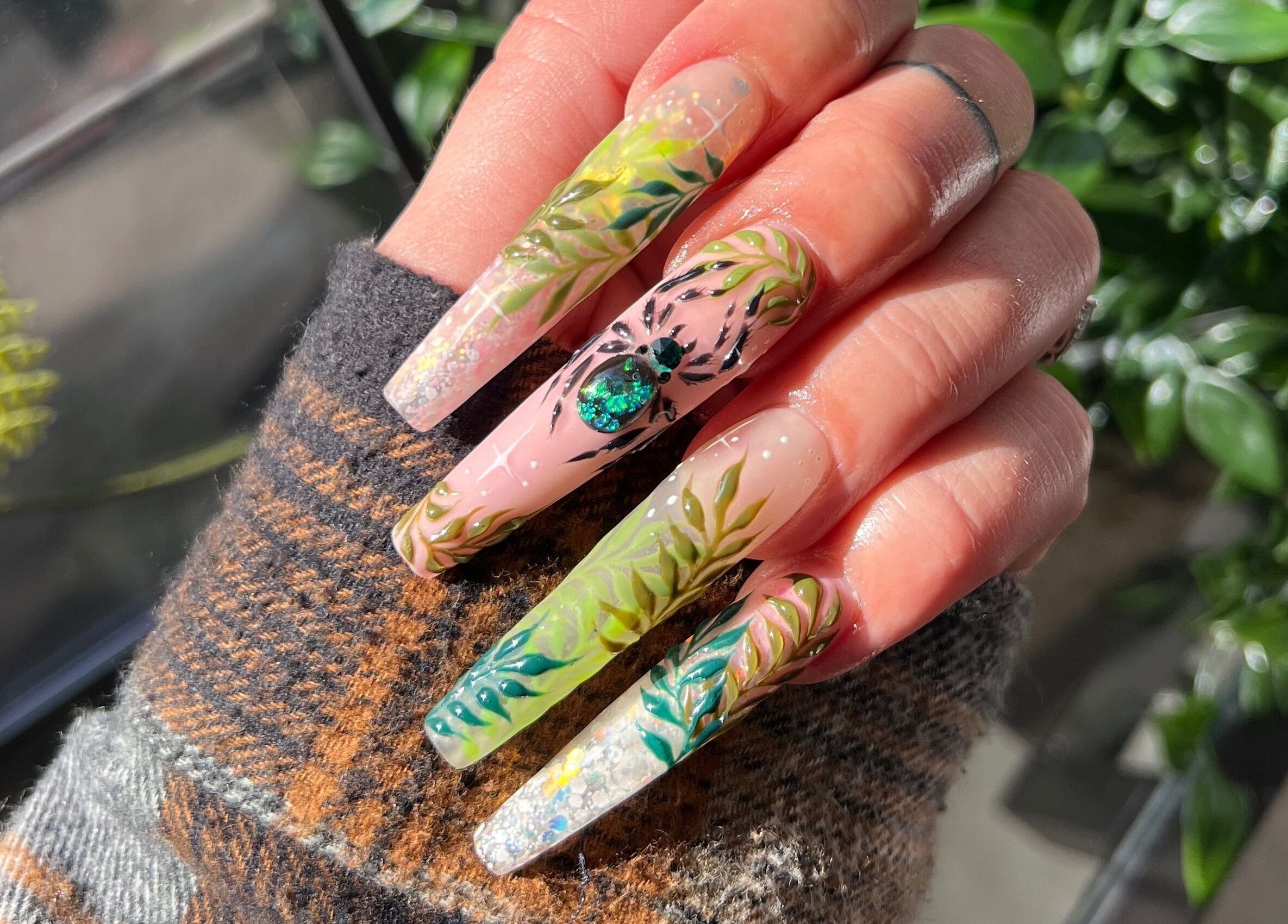 Intricate botanical nail art at Gatz Beauty Vision in Wellingborough, England, GB, showcasing detailed and vibrant designs.