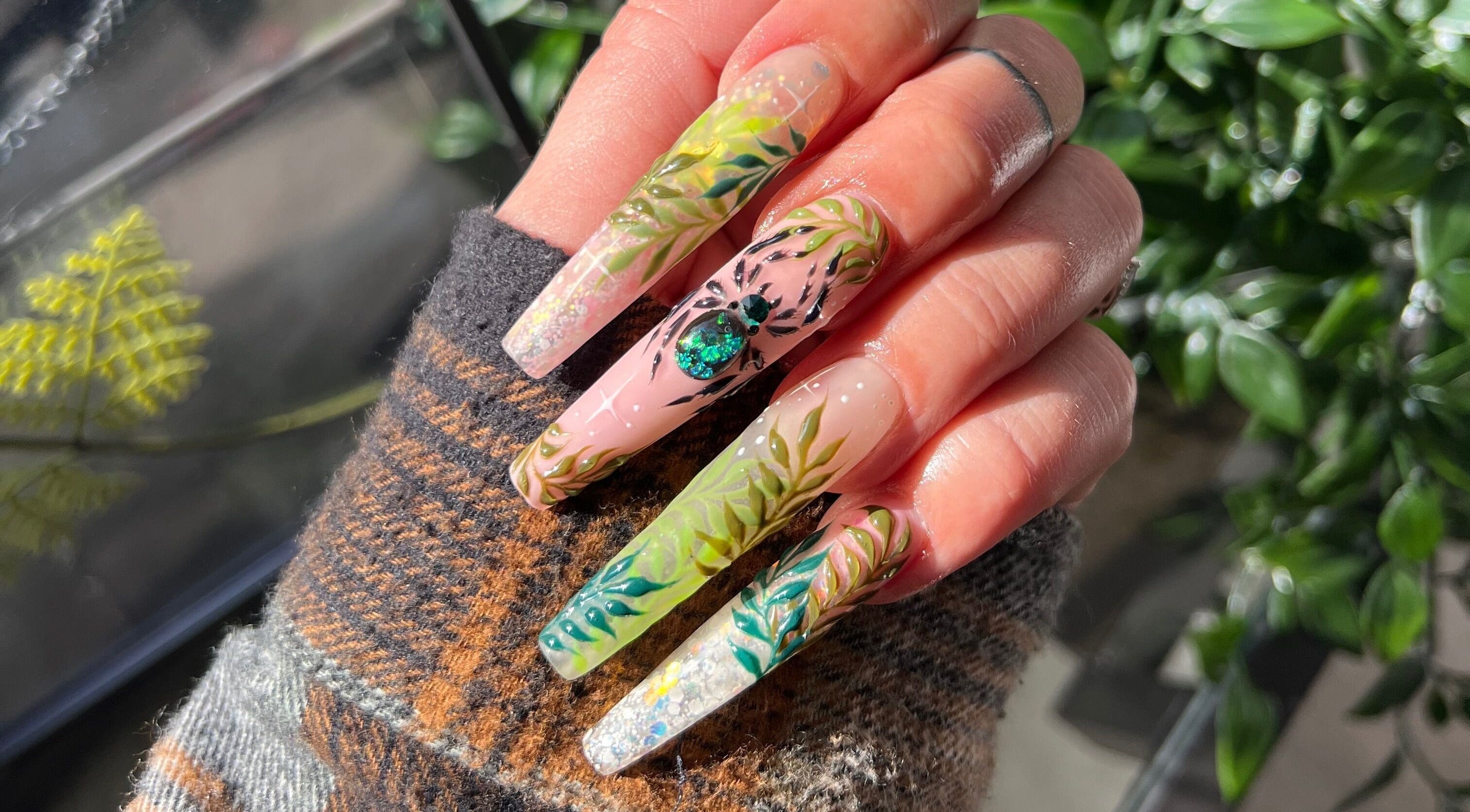 Intricate botanical nail art at Gatz Beauty Vision in Wellingborough, England, GB, showcasing detailed and vibrant designs.