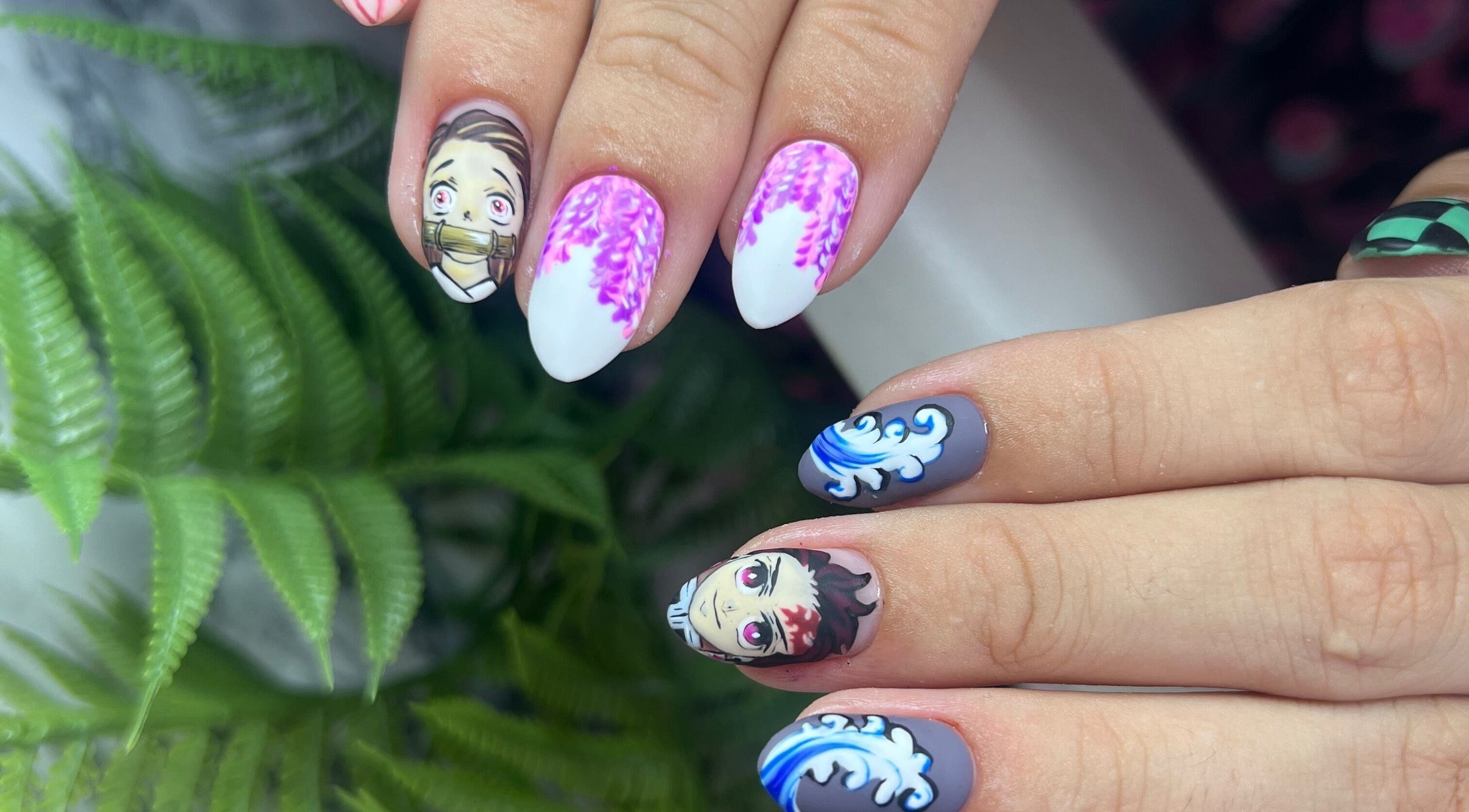 Anime-themed nail art at Gatz Beauty Vision, Wellingborough, England, GB. Vibrant designs with character details.