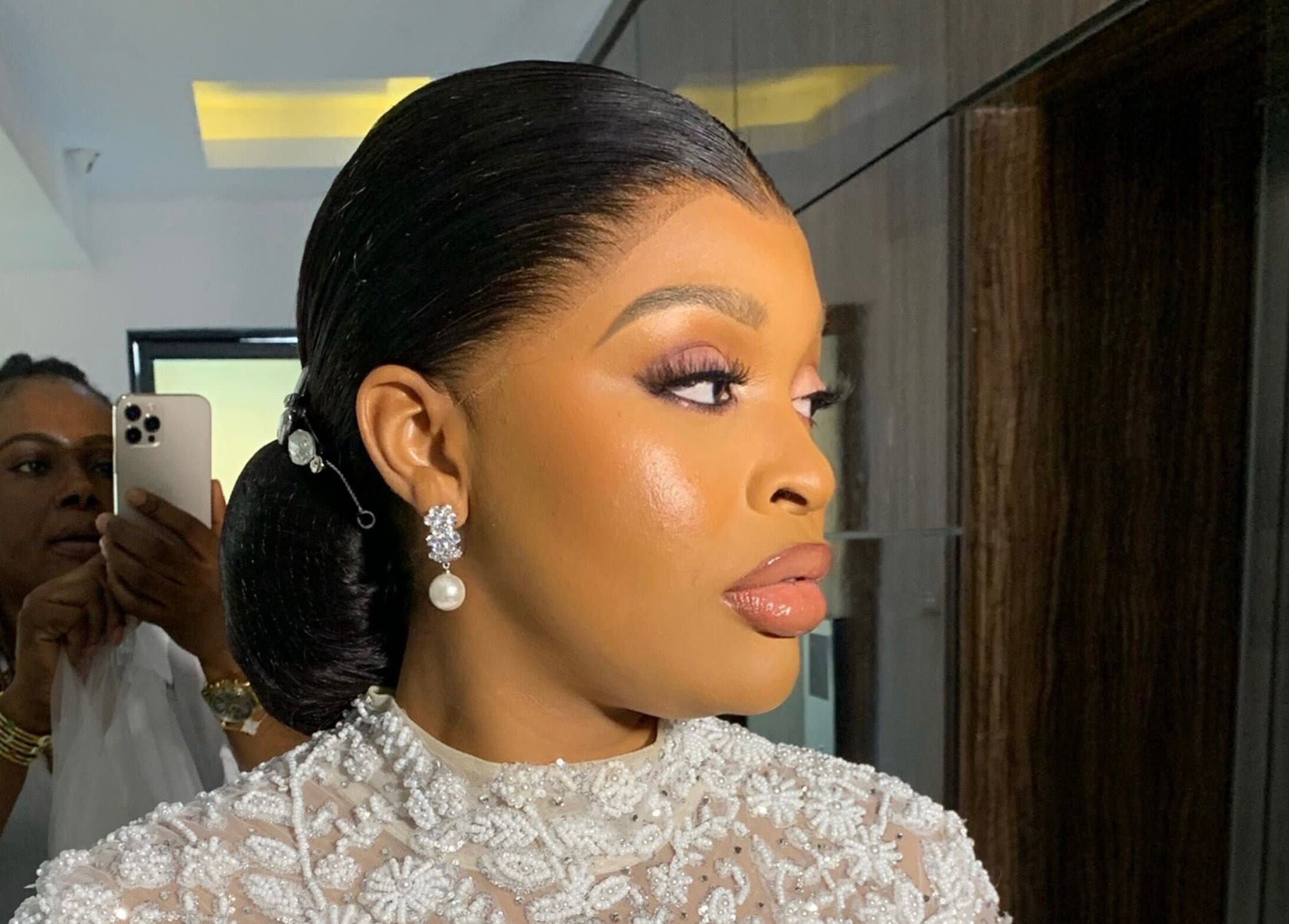 Elegant woman with intricate hairstyle and earrings at SOARS Artistry, Abuja, Federal Capital Territory, NG.