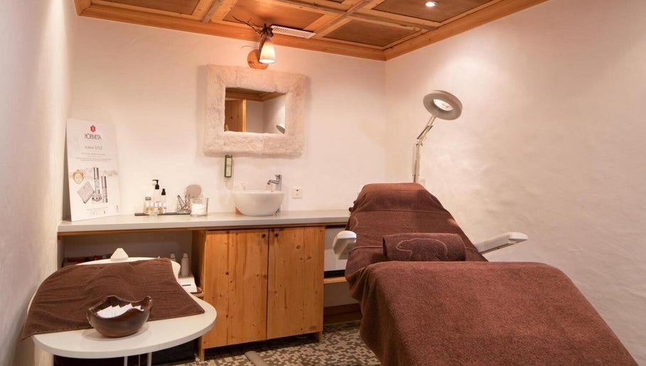 Salle de soins élégante à L'Alpage Spa, Crans-Montana, Valais, CH avec ambiance chaleureuse.