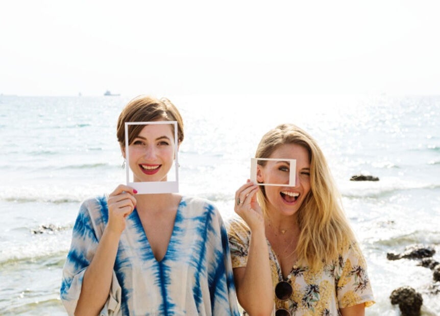 Two women enjoying the beach, enhancing the beauty atmosphere at 176 Princes Street, Dunedin 9016, Otago Region, NZ.