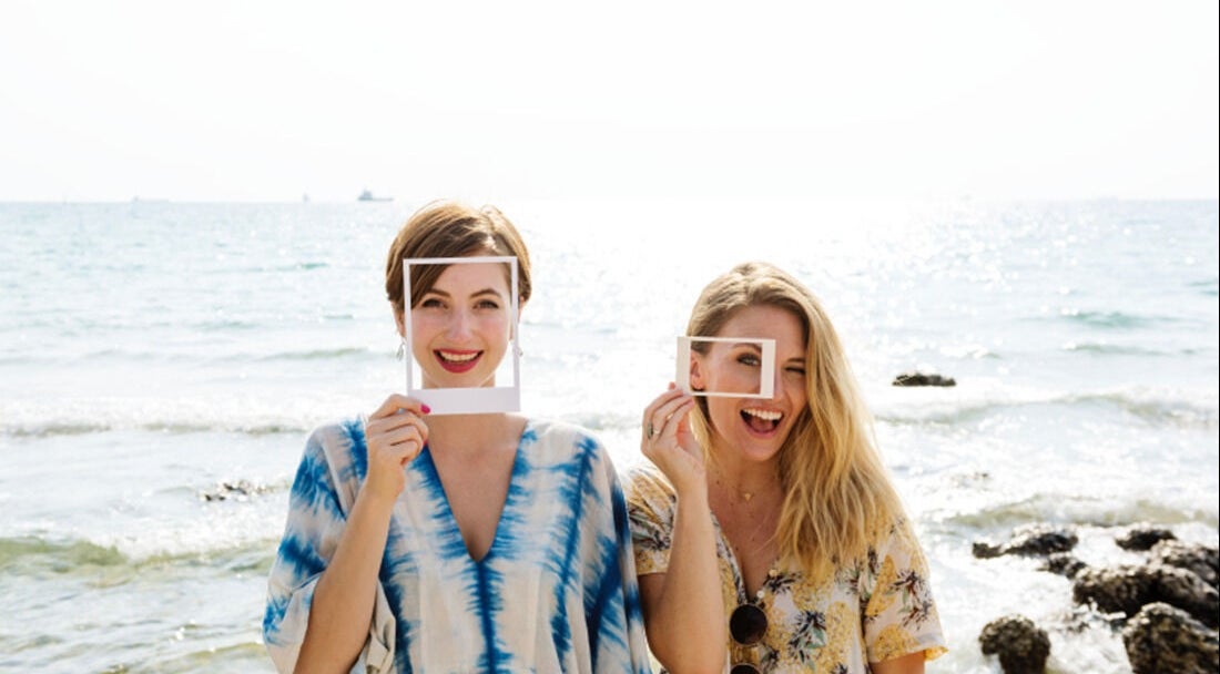 Two women enjoying the beach, enhancing the beauty atmosphere at 176 Princes Street, Dunedin 9016, Otago Region, NZ.