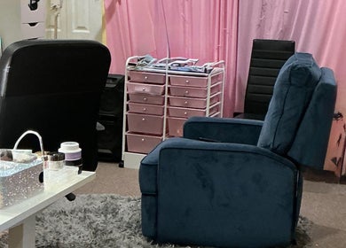 Relaxing beauty nook at Toxica Beauty Bar, Aurora, Illinois, US with cozy seating and organized pink storage.