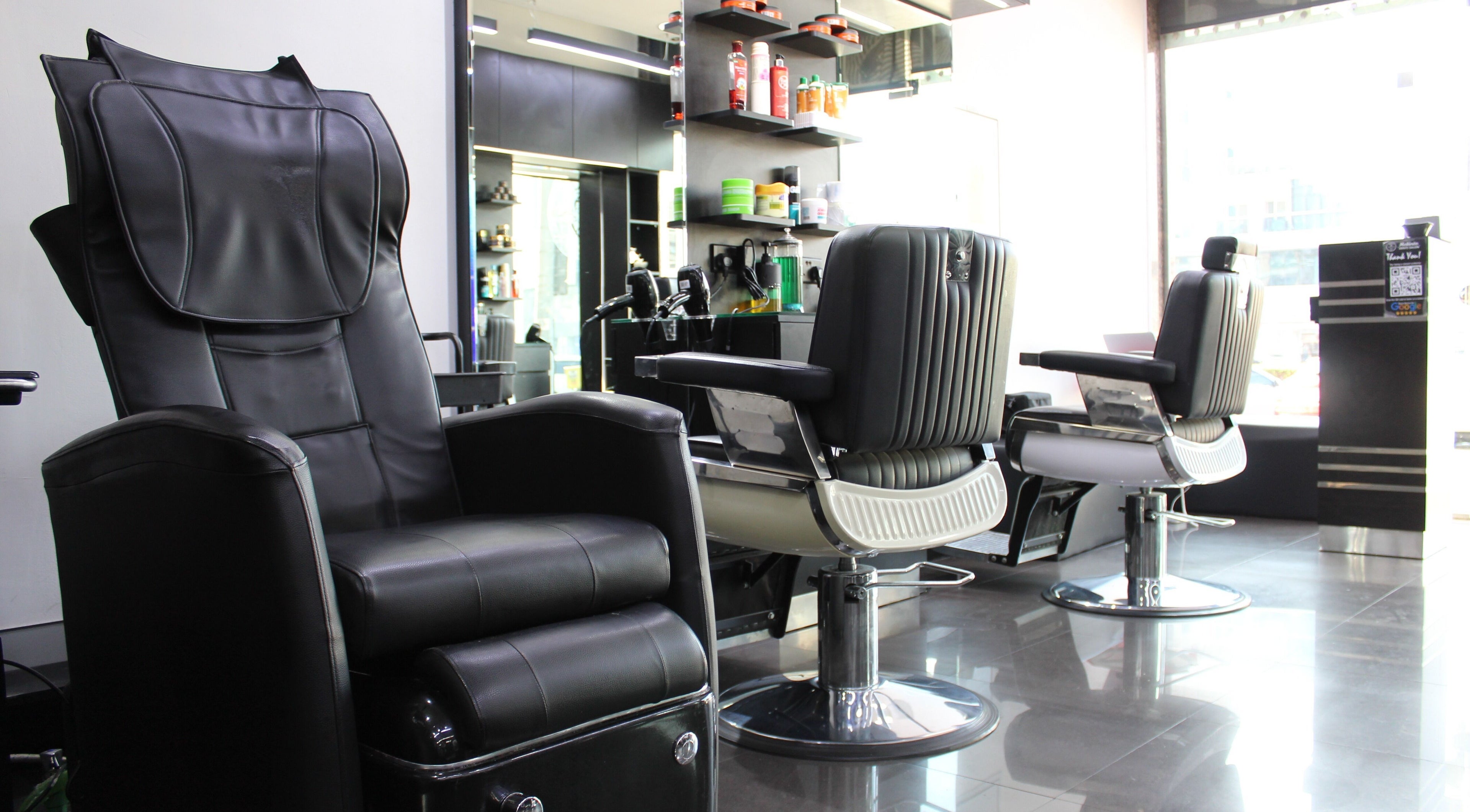 Interior view of Matinee Gents Salon in Dubai, AE, featuring sleek black barber chairs and modern decor.