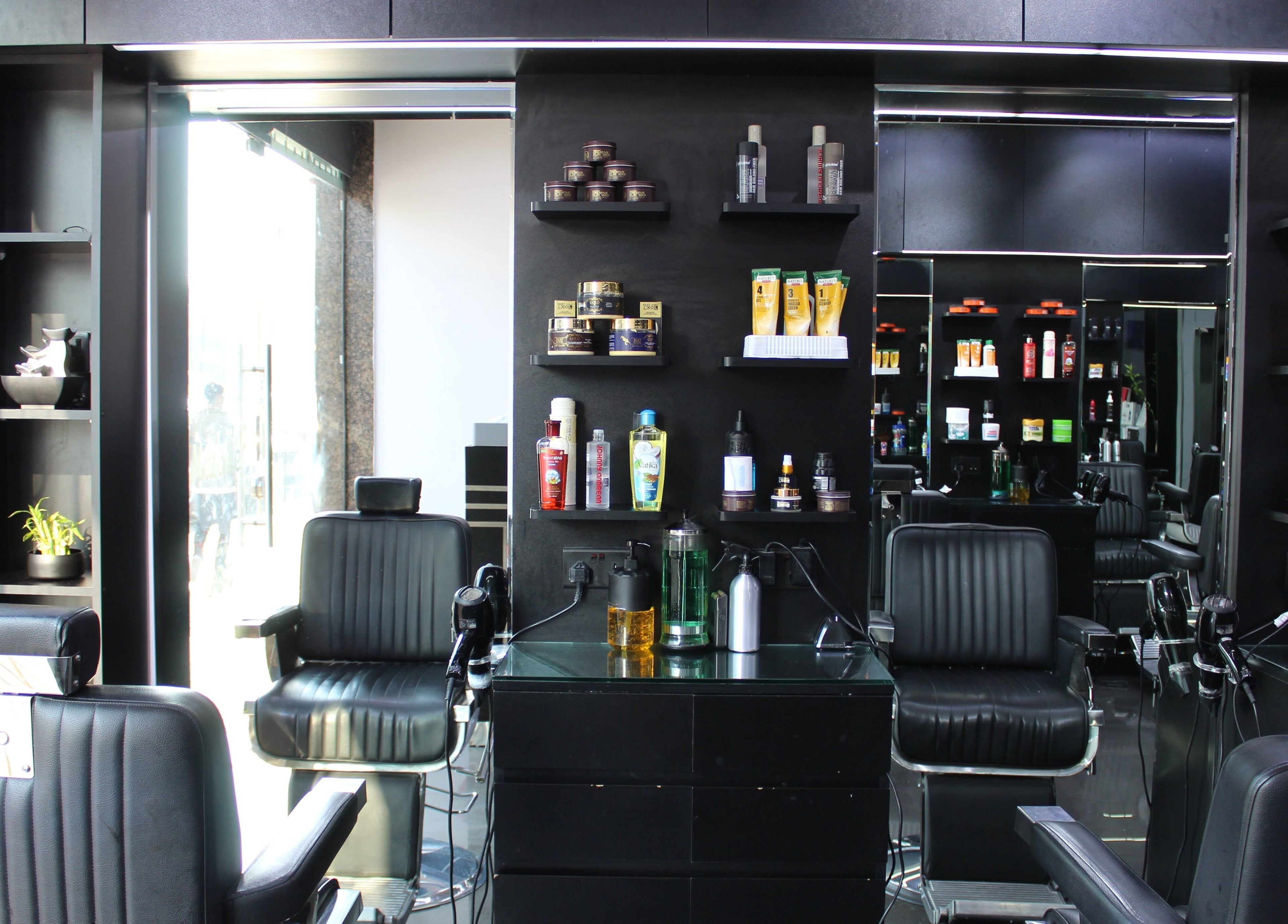Modern barber chairs at Matinee Gents Salon, Dubai, AE, showcasing sleek design and premium products.