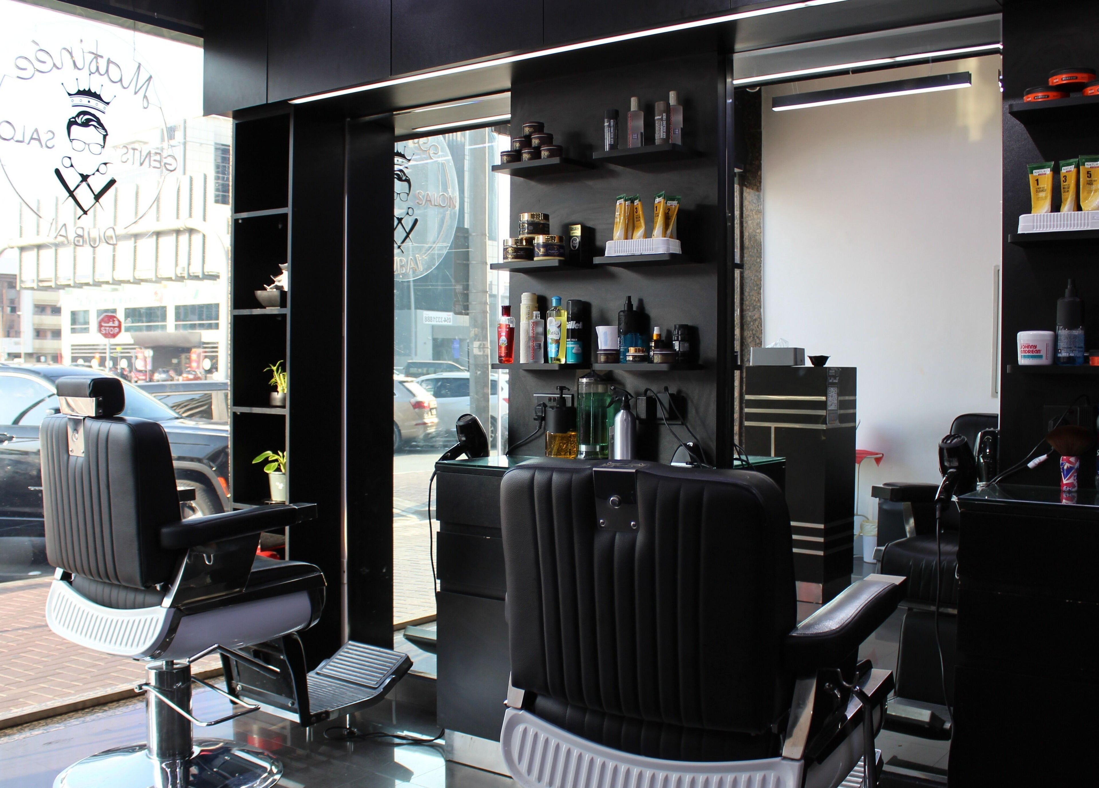 Modern interior of Matinee Gents Salon in Dubai, AE, with sleek barber chairs and styling products.