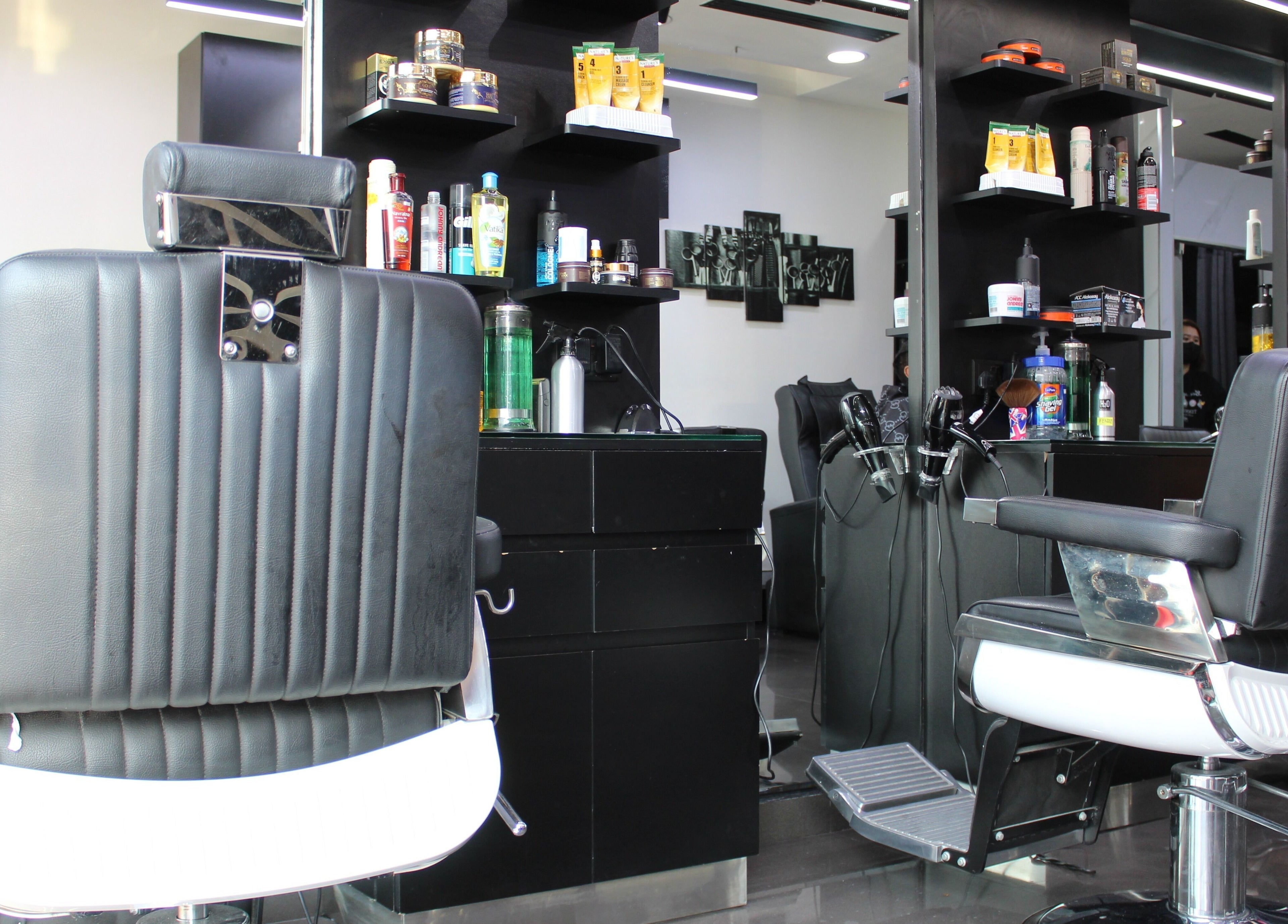 Modern interior of Matinee Gents Salon in Dubai, AE, featuring sleek black barber chairs and grooming products.