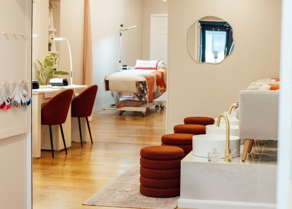 Chic interior of Trio Worcester salon in Worcester, England, GB, featuring nail stations and cozy pedicure chairs.