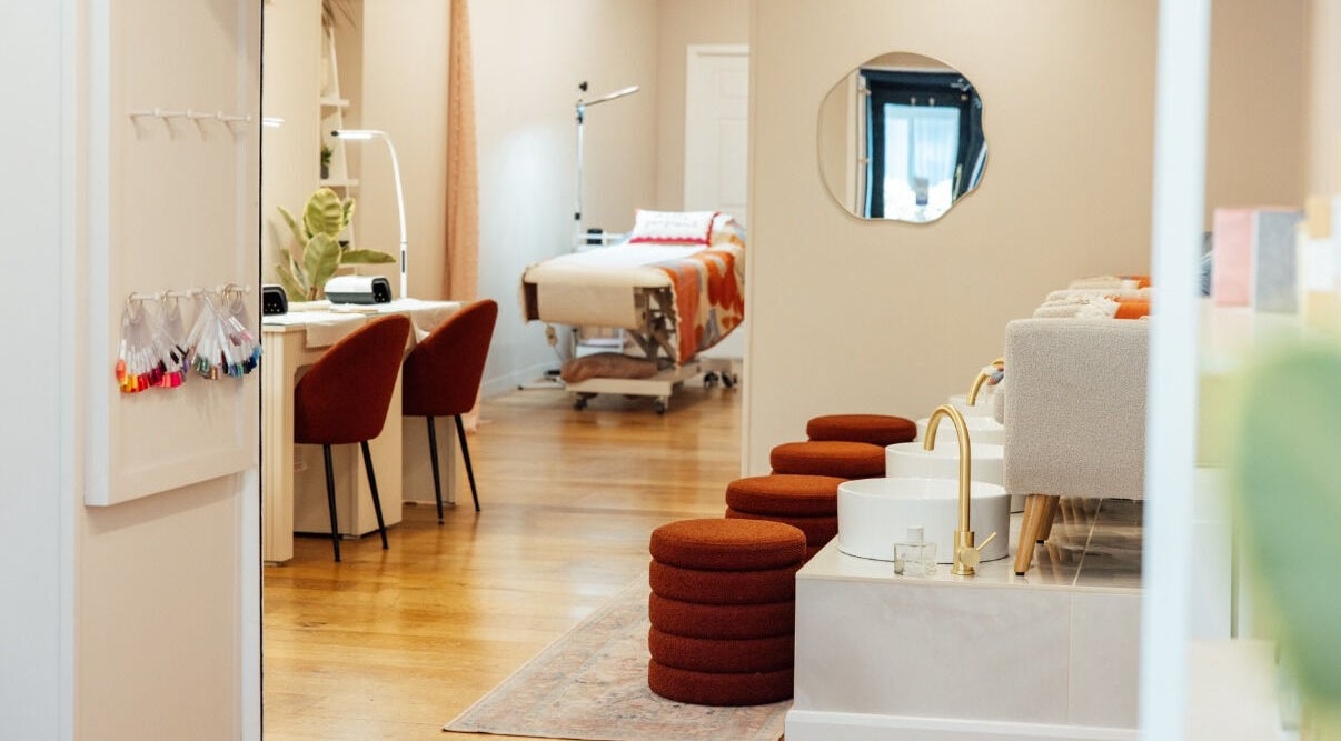 Chic interior of Trio Worcester salon in Worcester, England, GB, featuring nail stations and cozy pedicure chairs.