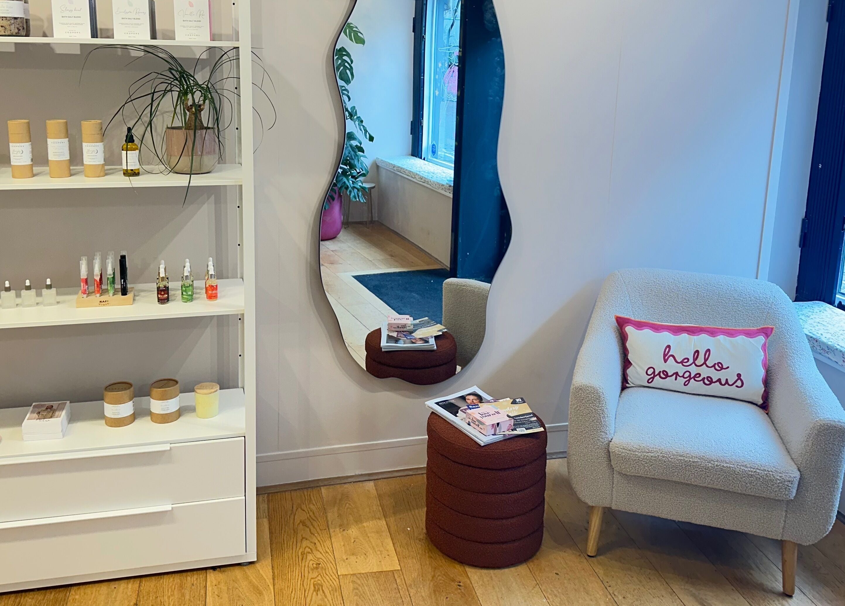 Chic beauty nook at Trio Worcester, Worcester, England, GB, showcasing products and a cozy seating area.