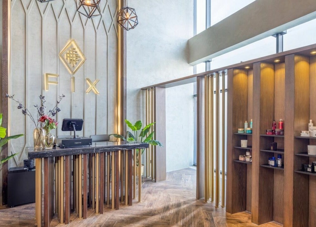 Elegant reception area of Fix Nails Spa and Salon, Al Khobar, Eastern Province, SA, with modern decor and products displayed.