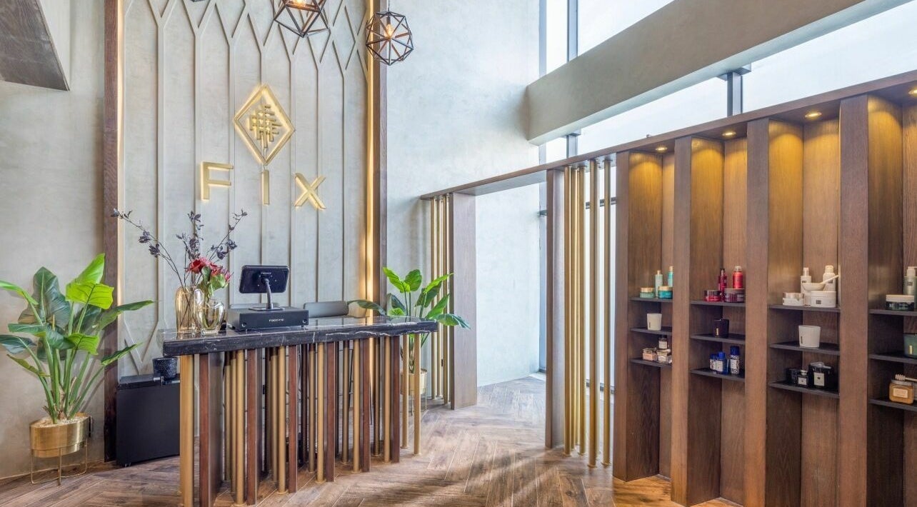 Elegant reception area of Fix Nails Spa and Salon, Al Khobar, Eastern Province, SA, with modern decor and products displayed.