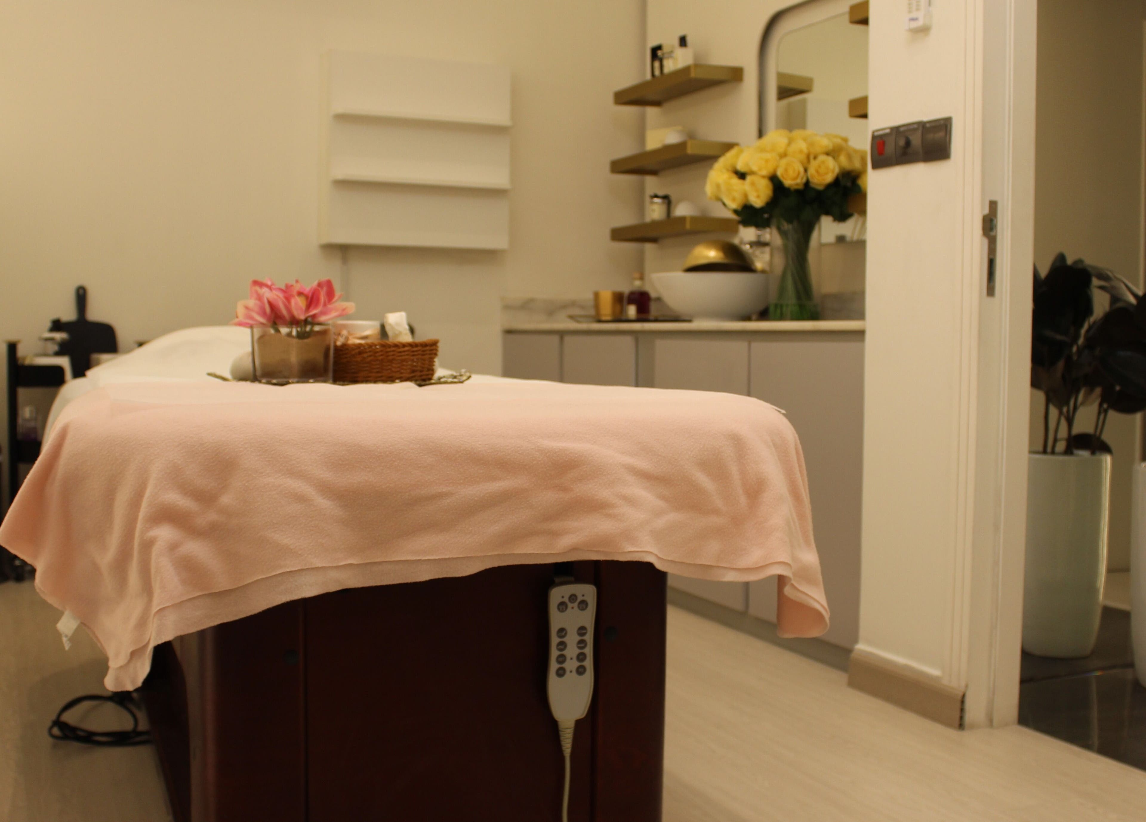 Cozy treatment room at Skin Glow Facial Center in Abu Dhabi, AE, showcasing serene ambience and plush decor.
