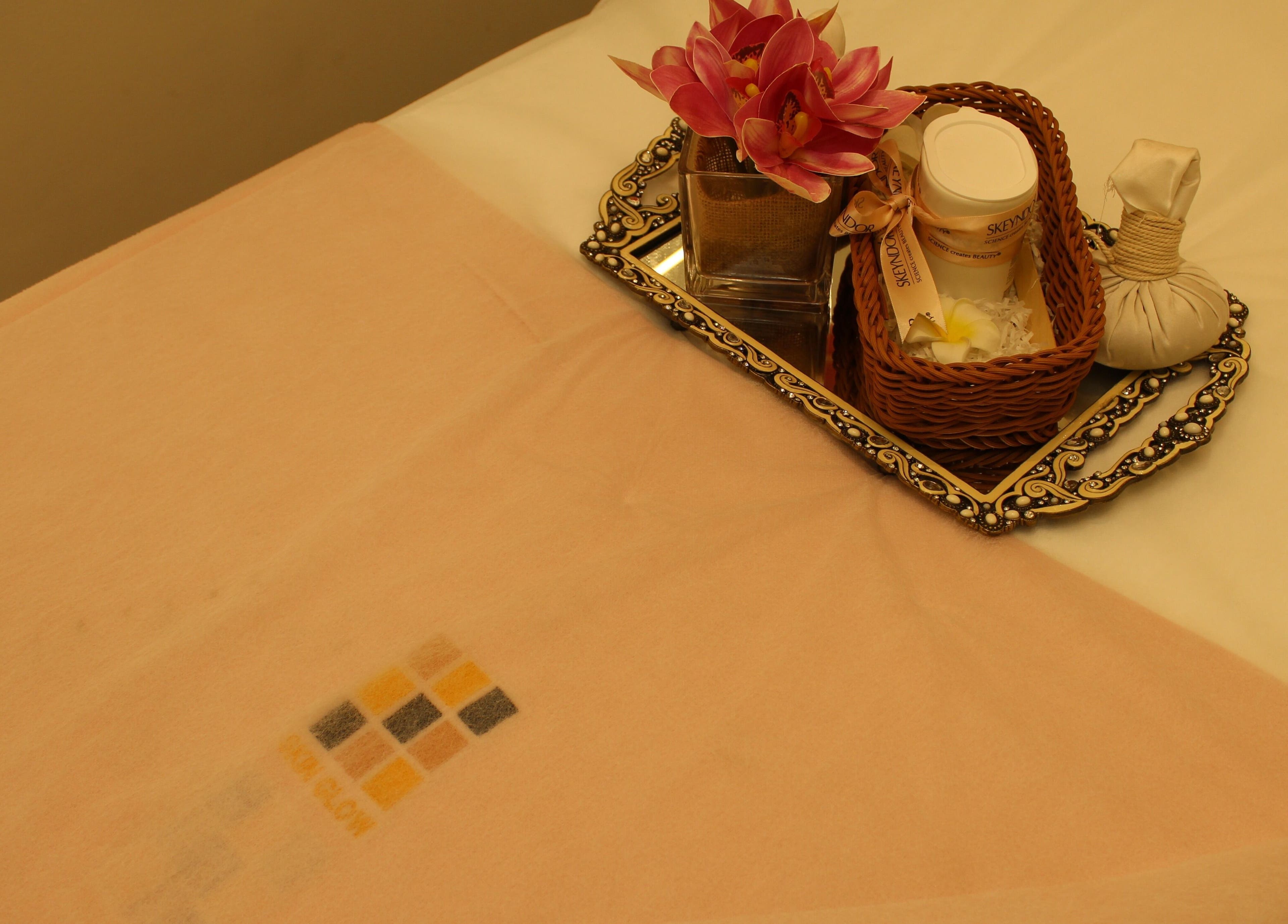 Luxurious spa setup with flowers at Skin Glow Facial Center, Abu Dhabi, AE, enhancing relaxation and rejuvenation.