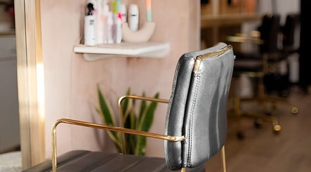 Modern salon chair at Carley Bayne Hair, Epsom, England, GB with stylish decor and hair products.