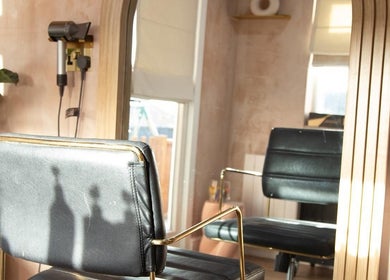 Luxury salon chair and mirror at Carley Bayne Hair, Epsom, England, GB offering a serene hairstyling atmosphere.