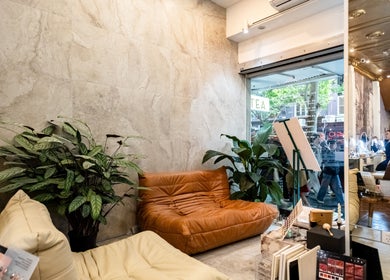 Inviting lounge with leather sofas and plants at Timeless Style in Melbourne, Victoria, AU.