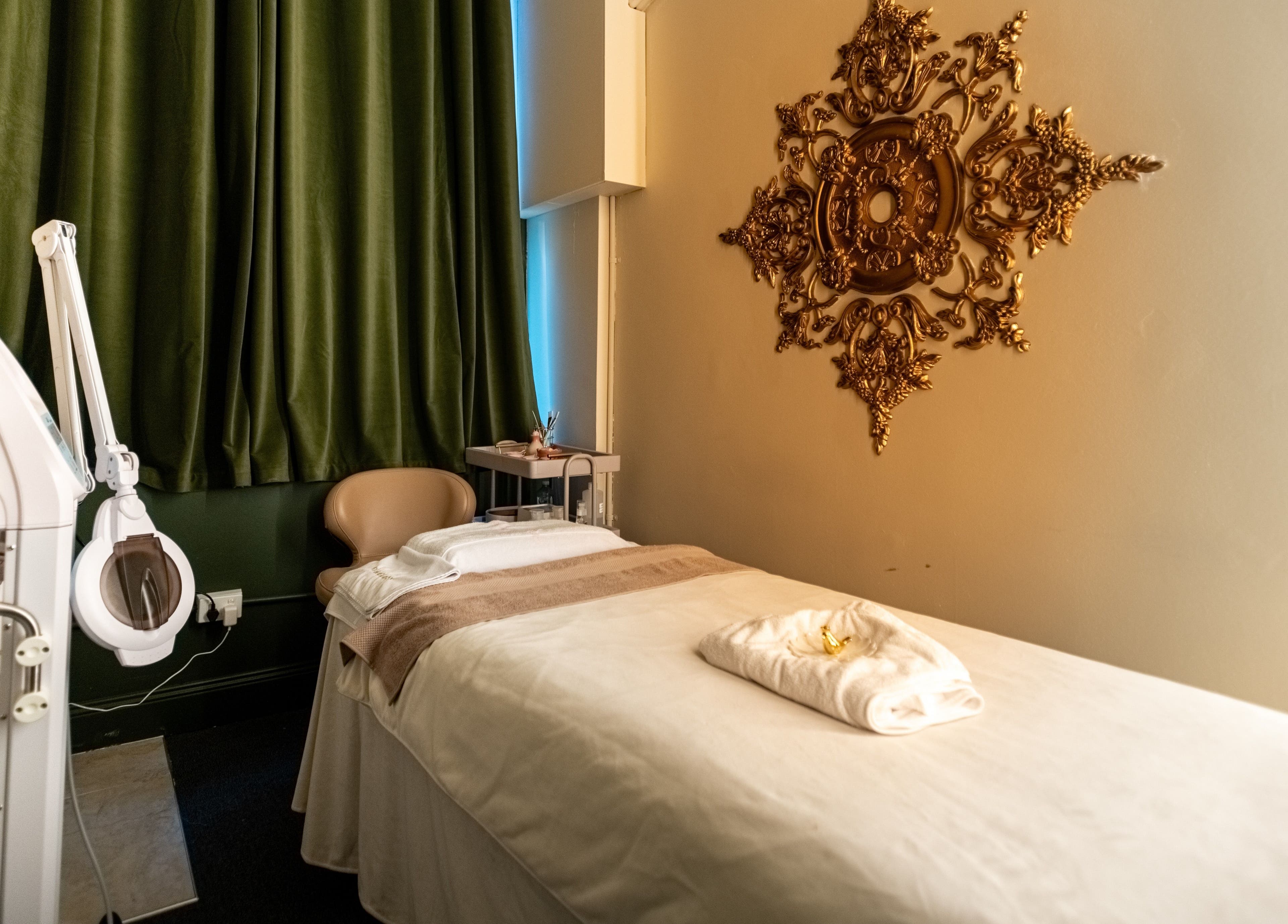 Relaxing treatment room at Timeless Style, Melbourne, Victoria, AU featuring ornate wall art and plush bed.