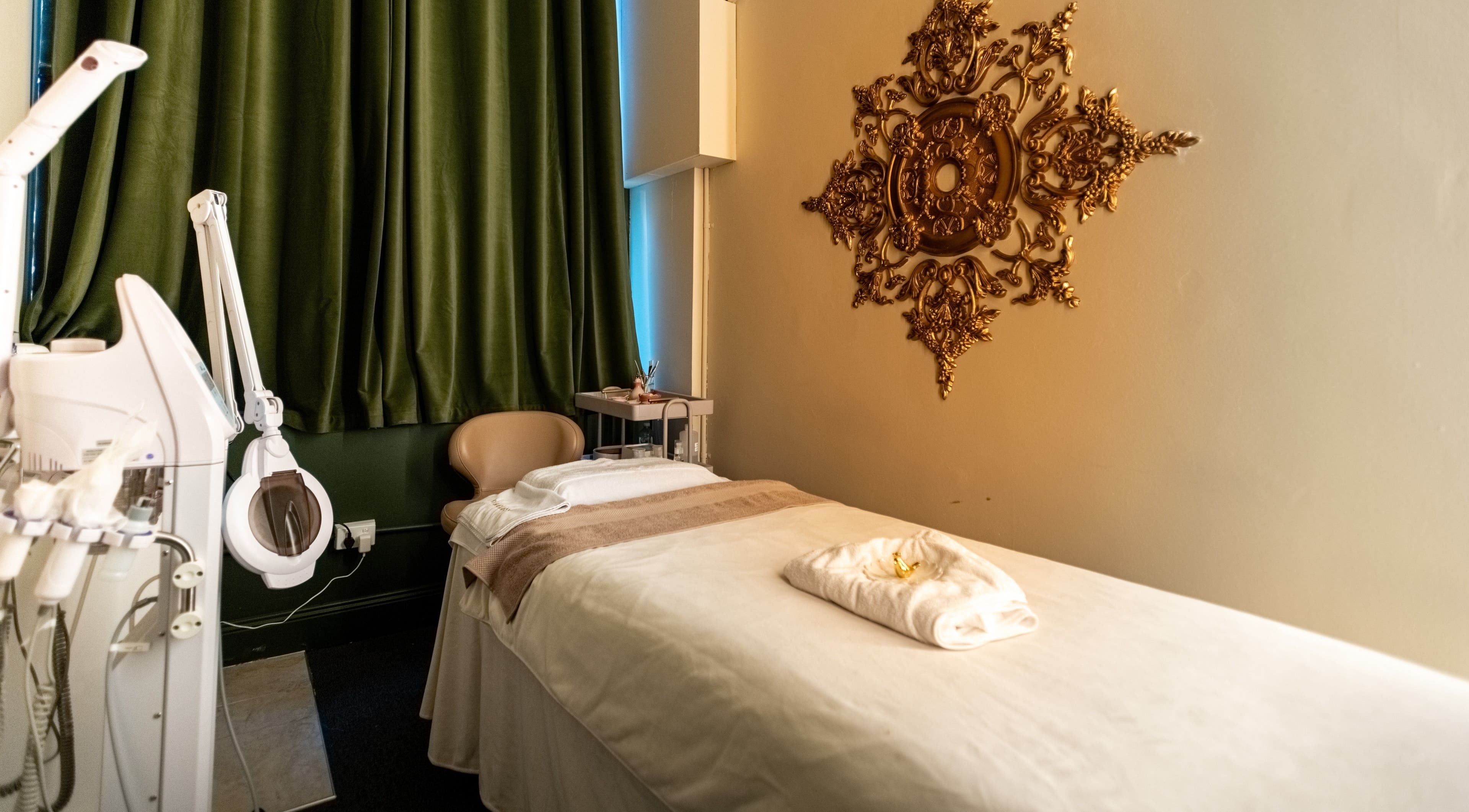 Relaxing treatment room at Timeless Style, Melbourne, Victoria, AU featuring ornate wall art and plush bed.