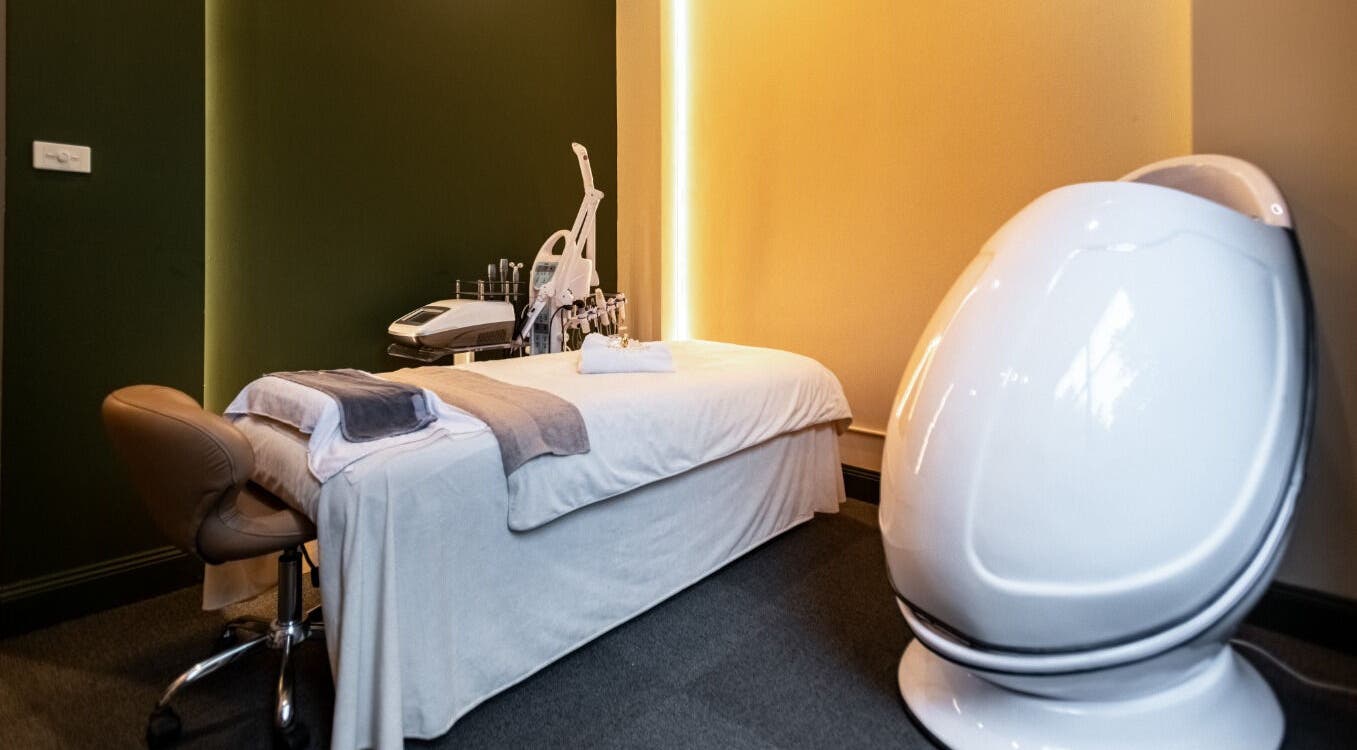 Modern treatment room at Timeless Style, Melbourne, Victoria, AU, featuring sleek massage bed and equipment.