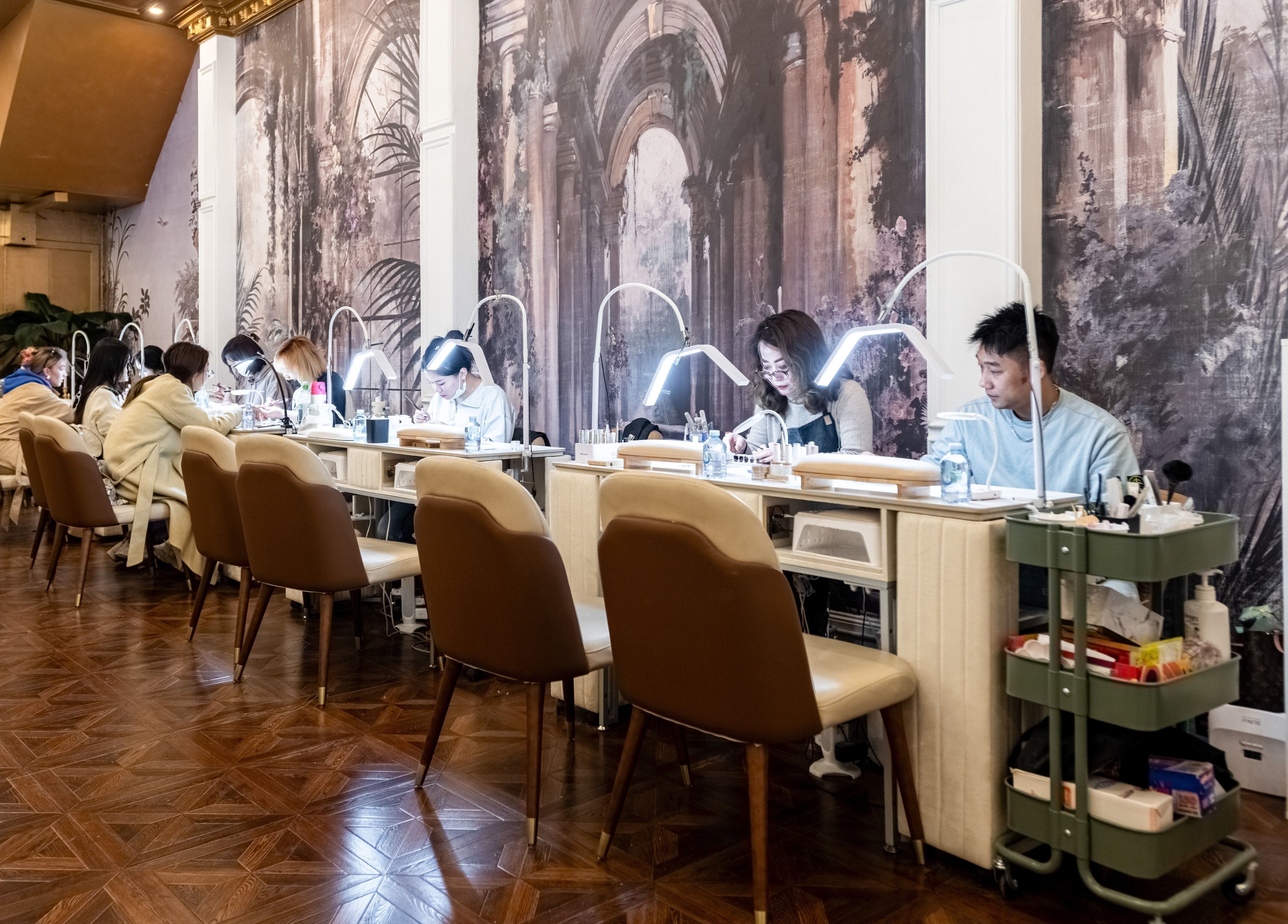 Spacious nail salon at Timeless Style, Melbourne, Victoria, AU with patrons and artists at workstations.